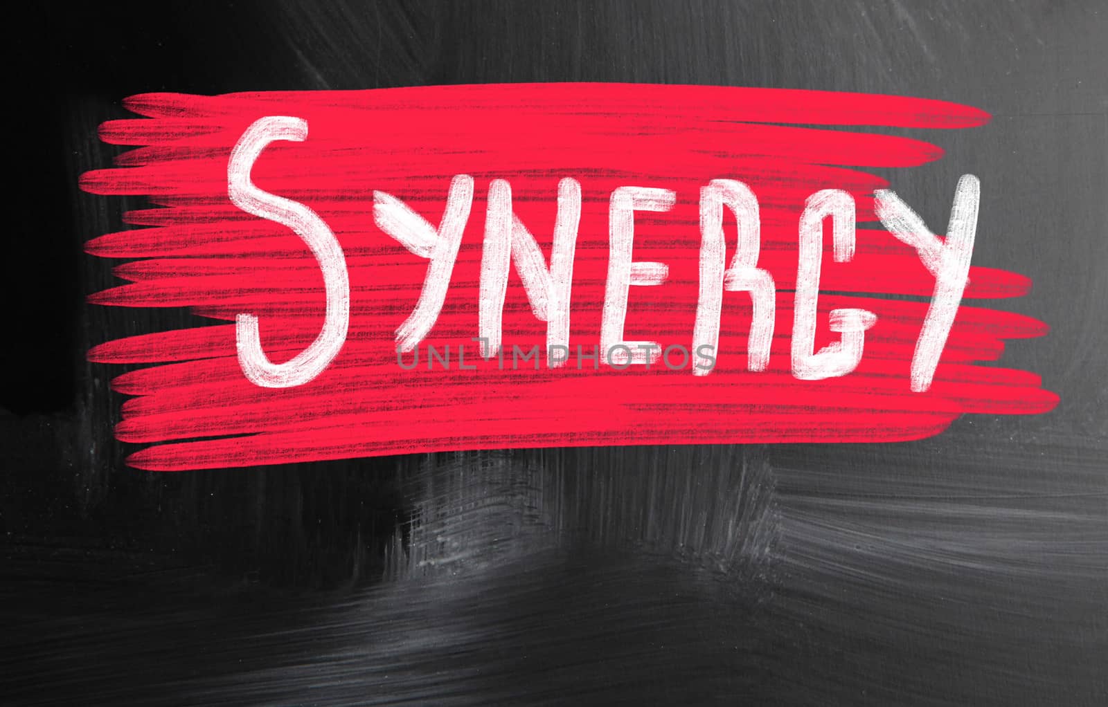 synergy handwritten with chalk on a blackboard