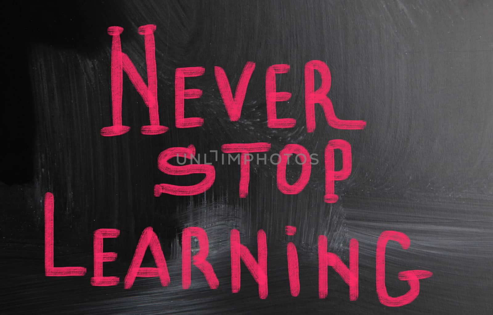 never stop learning handwritten with chalk on a blackboard by nenov