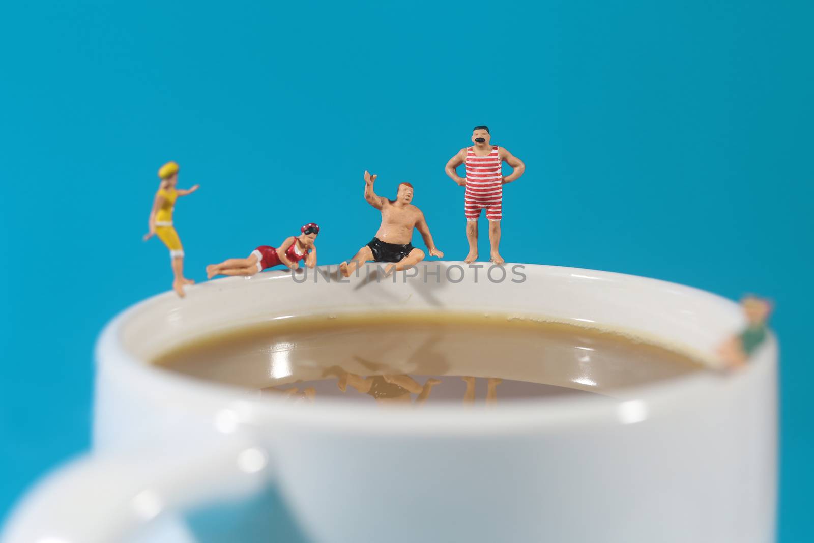 Miniature Plastic People Swimming in Coffee