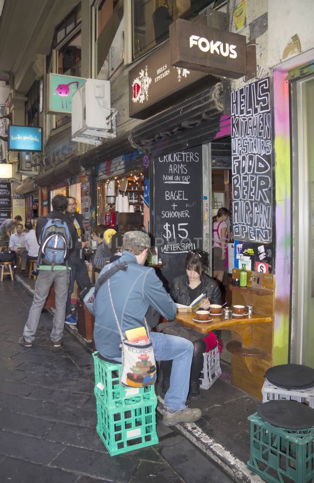 Melbourne, Australia-March 18th 2013: Tourists taking coffee in Melbourne's lanes. The Victorian era lanes and arcades of Melbourne have become an important tourist and cultural landmark.