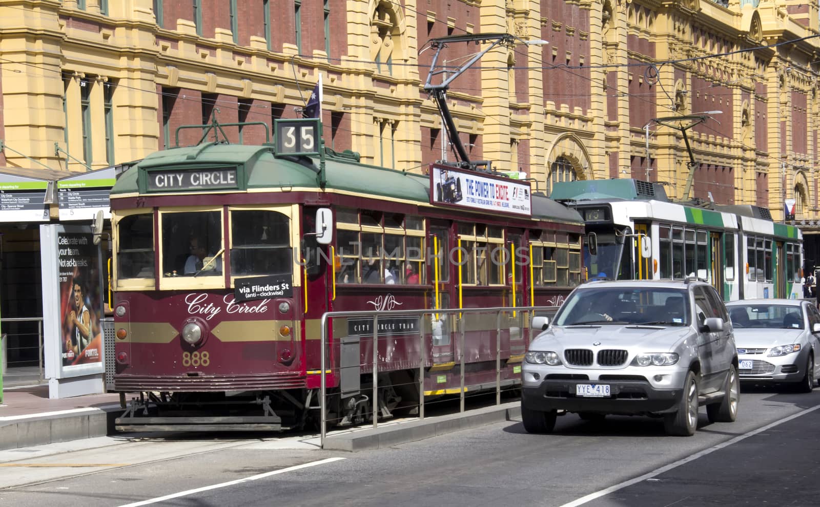 Melbourne, Australia-March 18th 2013: City Circle tram and cars outside Flinders St station. The tram route is a free service running around Melbourne's CBD.