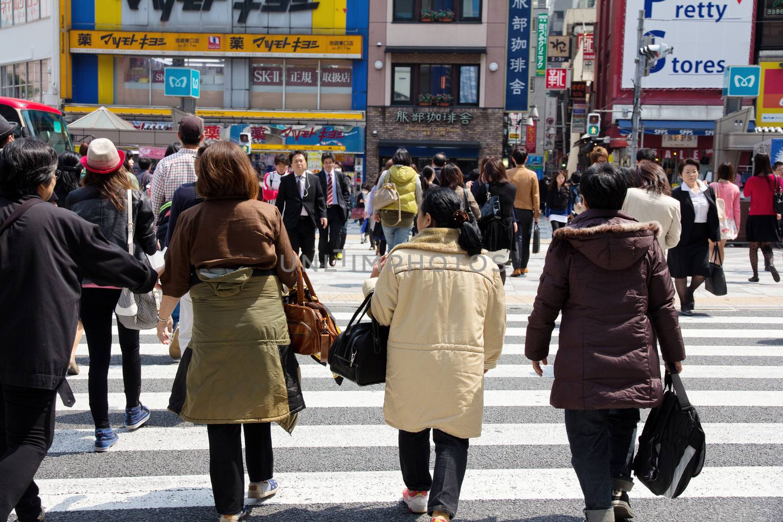 Tokyo, Japan - April 15, 2014 Crowds of pedestrians crossing the busy downtown streets of Shibuya, the most important commercial center in Tokyo, Japan