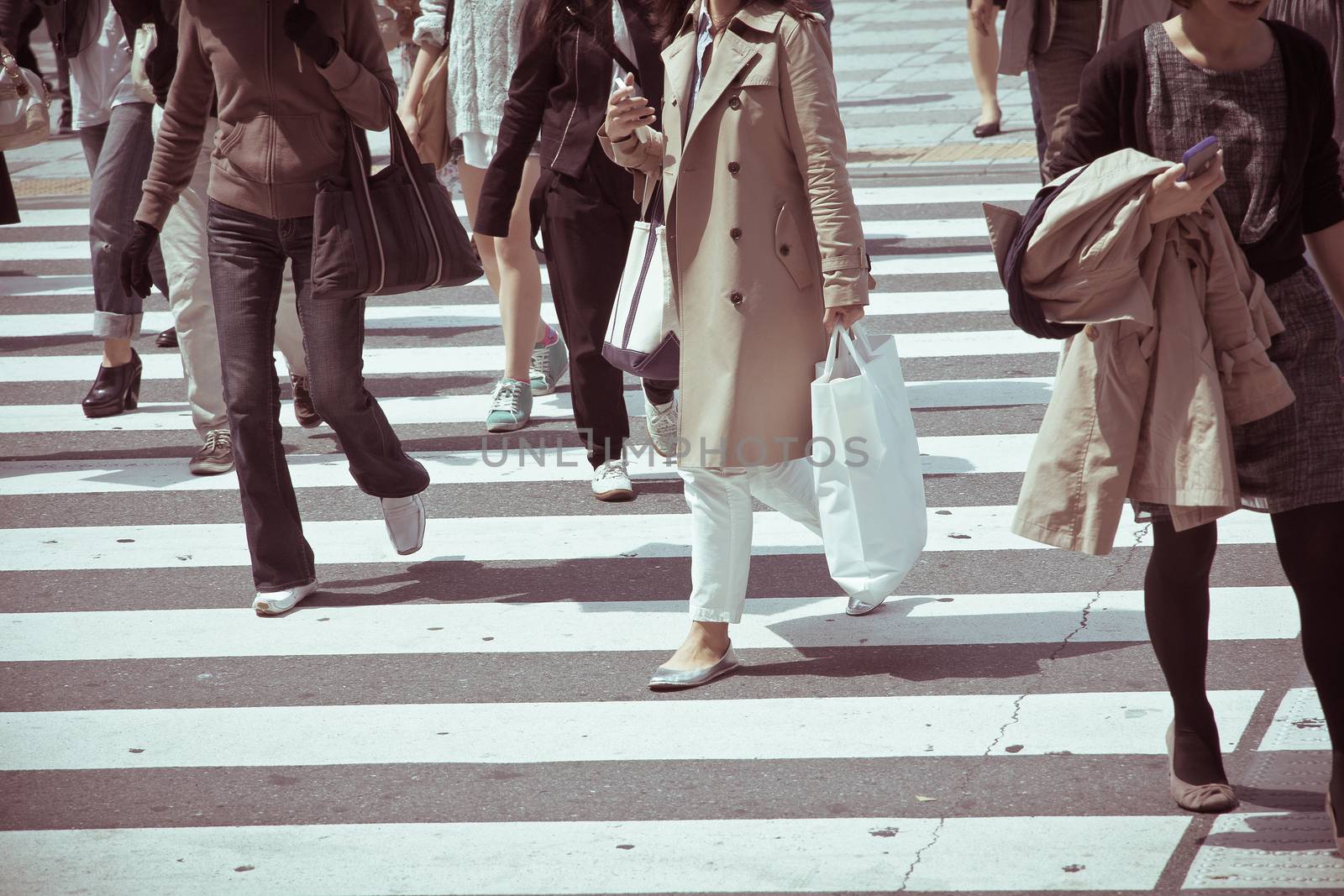 Crowds of pedestrians crossing the street