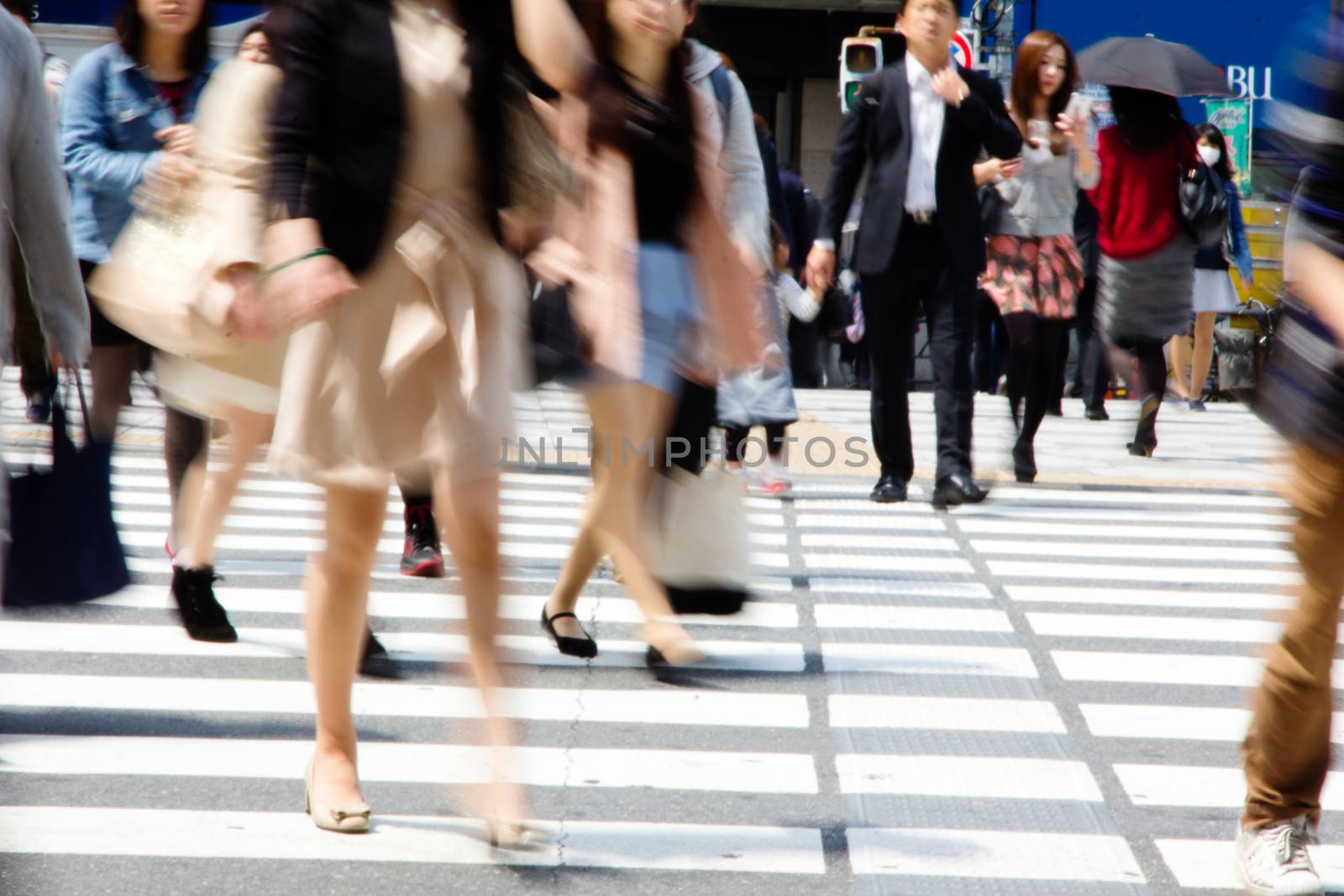 Crowds of pedestrians crossing the street