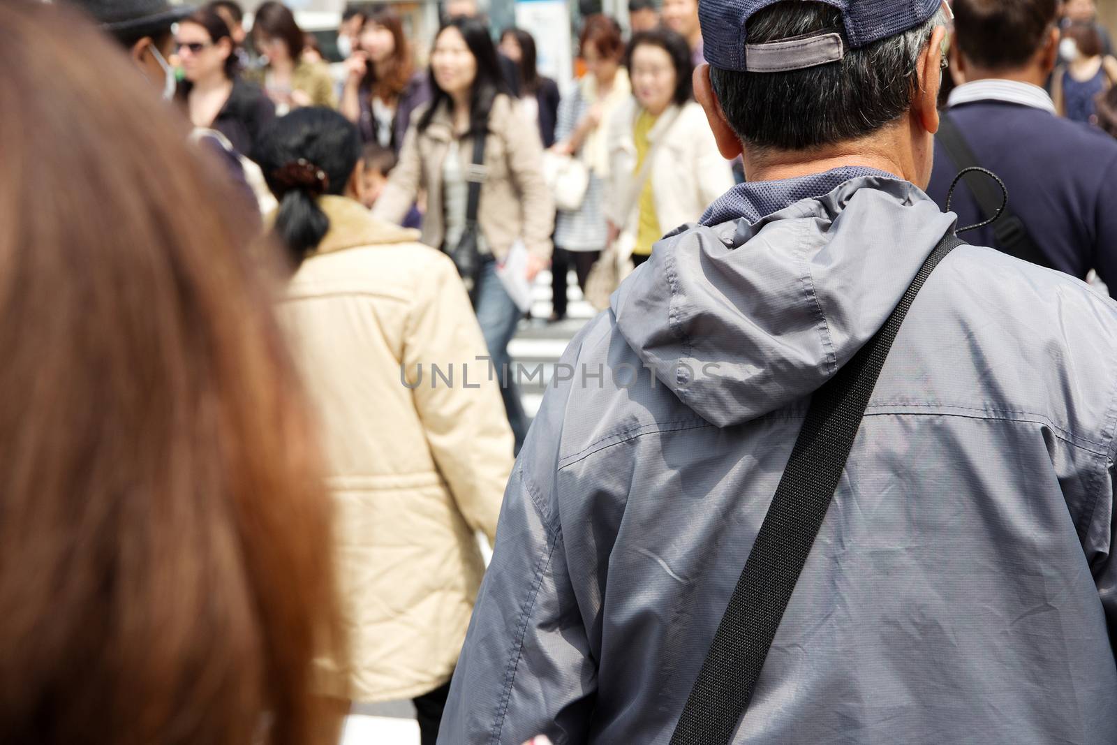 Tokyo, Japan - April 15, 2014 Crowds of pedestrians crossing the busy downtown streets of Shibuya, the most important commercial center in Tokyo, Japan