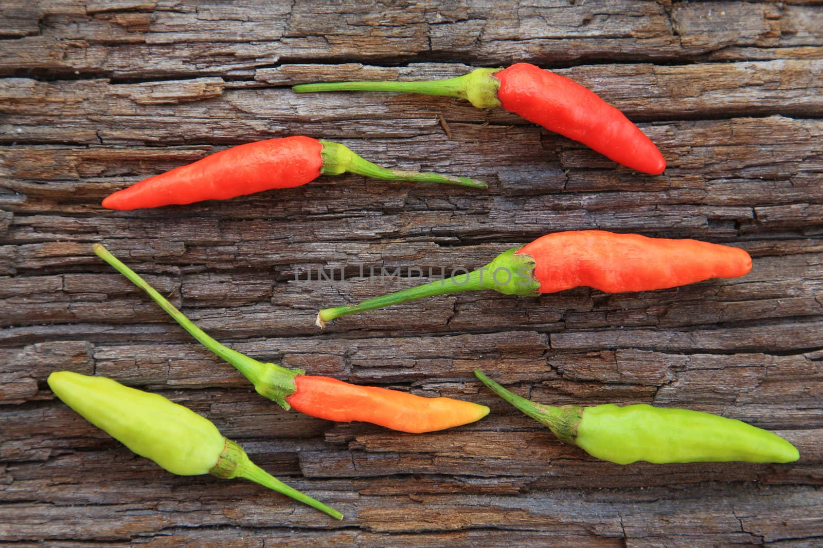 Hot chili peppers on old wooden