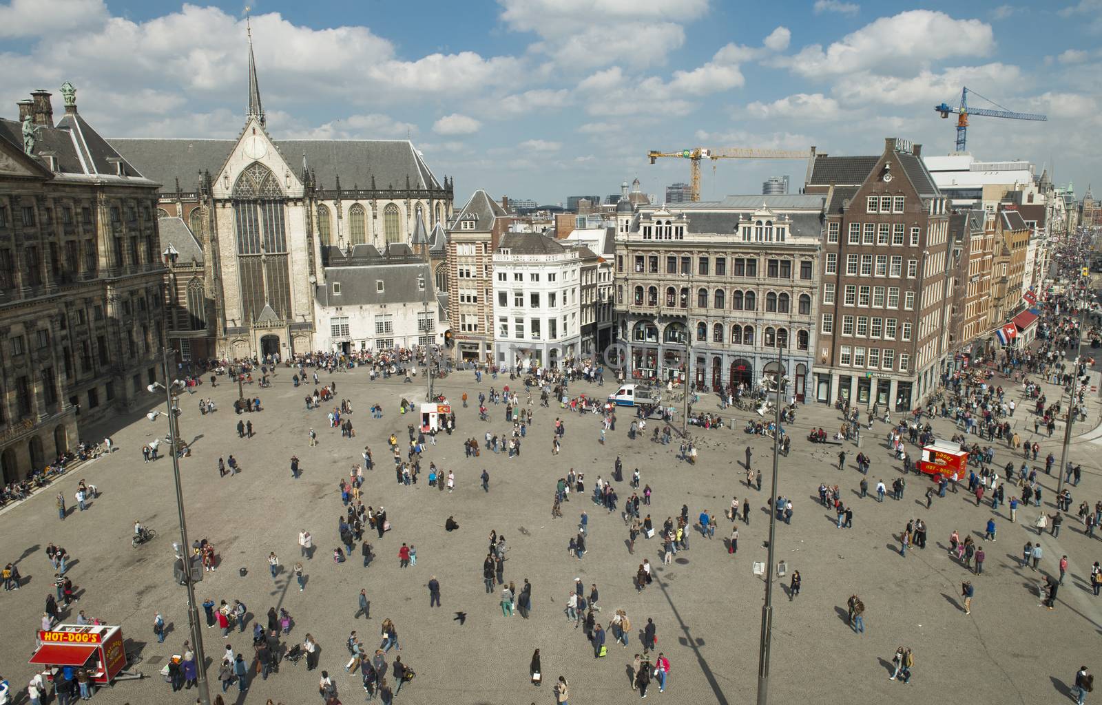 Amsterdam, The Netherlands - April 05, 2014; The Dam square is the very centre and heart of Amsterdam and has seen many historical dramas. The big attractions in Dam Square, Royal Palace.  Although no longer home to the Dutch Royal family, this grand 17th century Royal Palace is still used to hold official receptions.