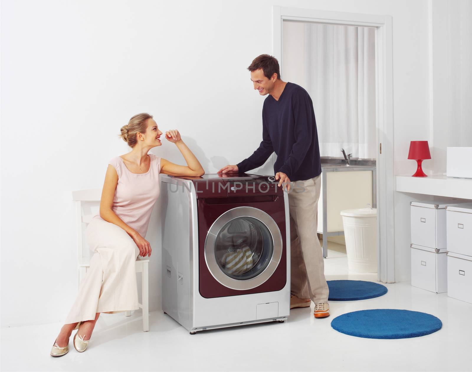 Housework, young woman and man doing laundry at home
