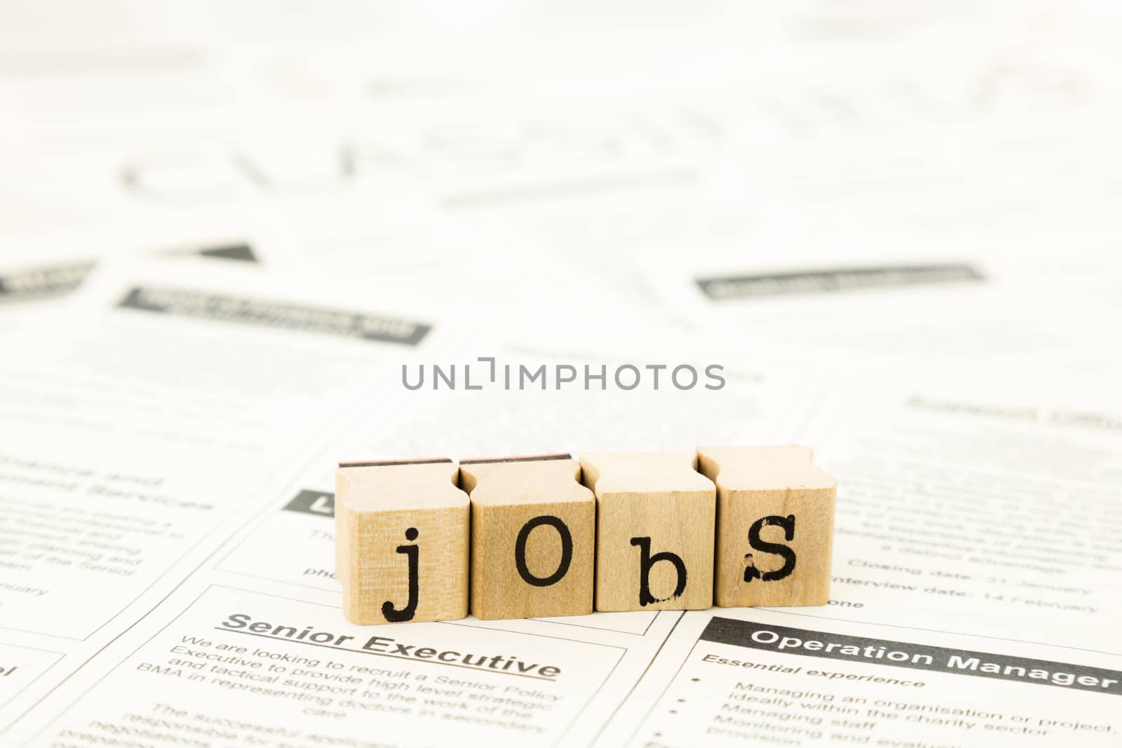 closeup jobs wording on classifieds ads and newspaper, recruitment and employment concepts and ideas