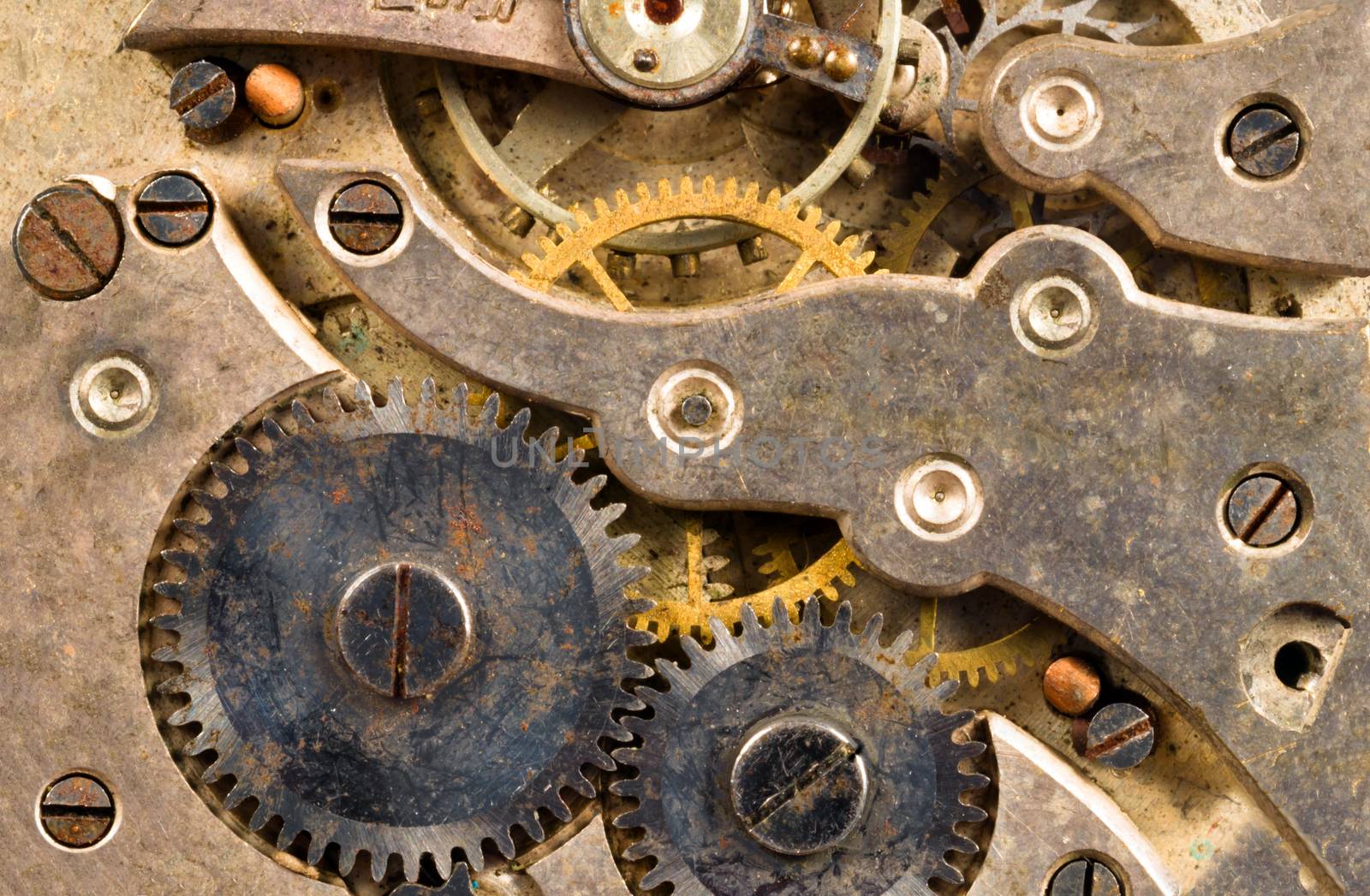 Extreme close up of the inside workings of a jeweled pocket watch time piece