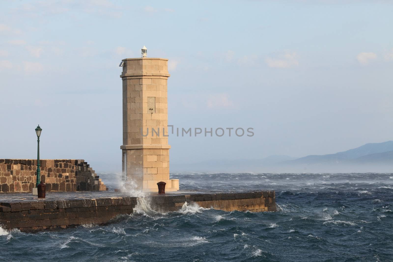 Lighthouse with stormy sea waves