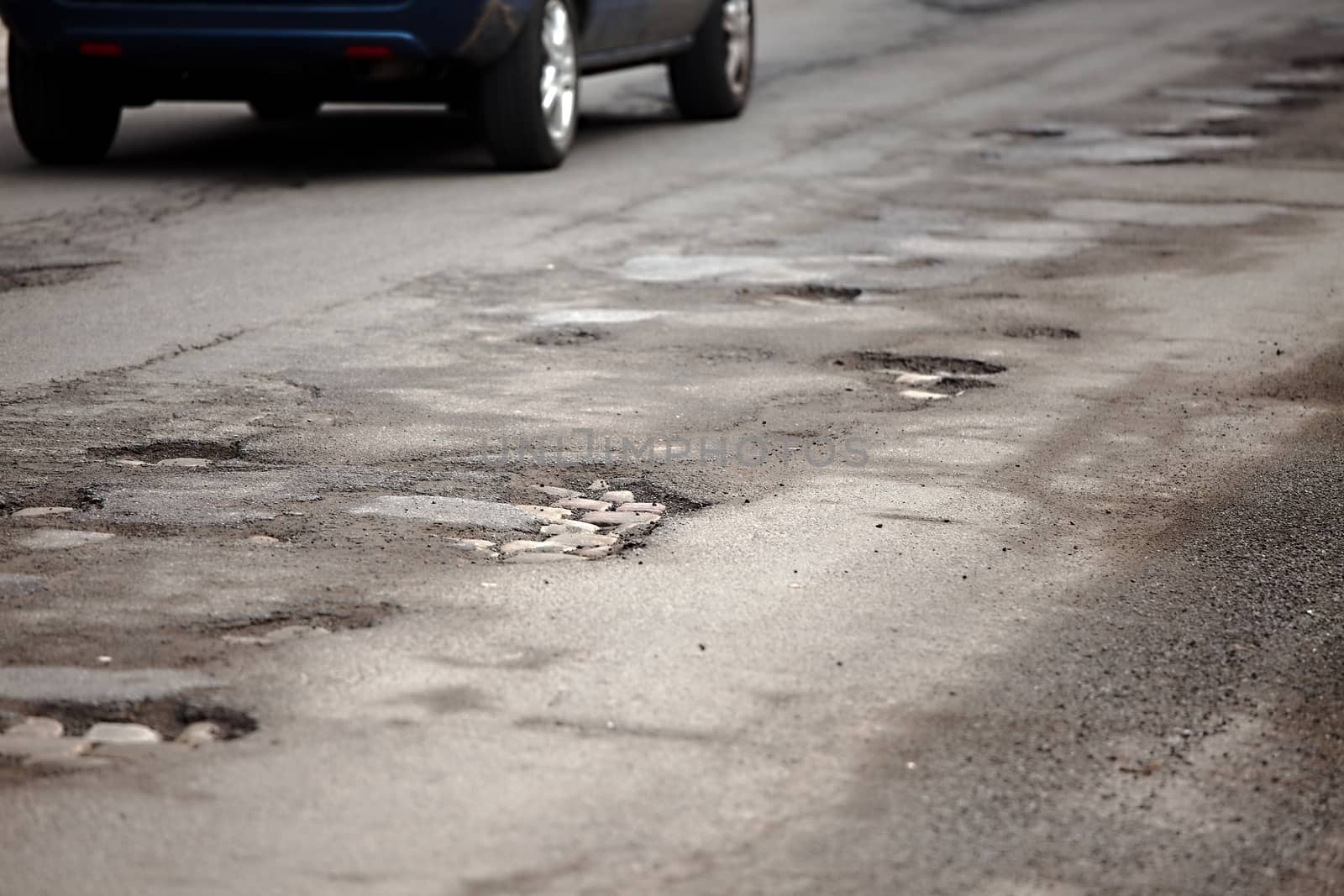 Very bad quality road with potholes