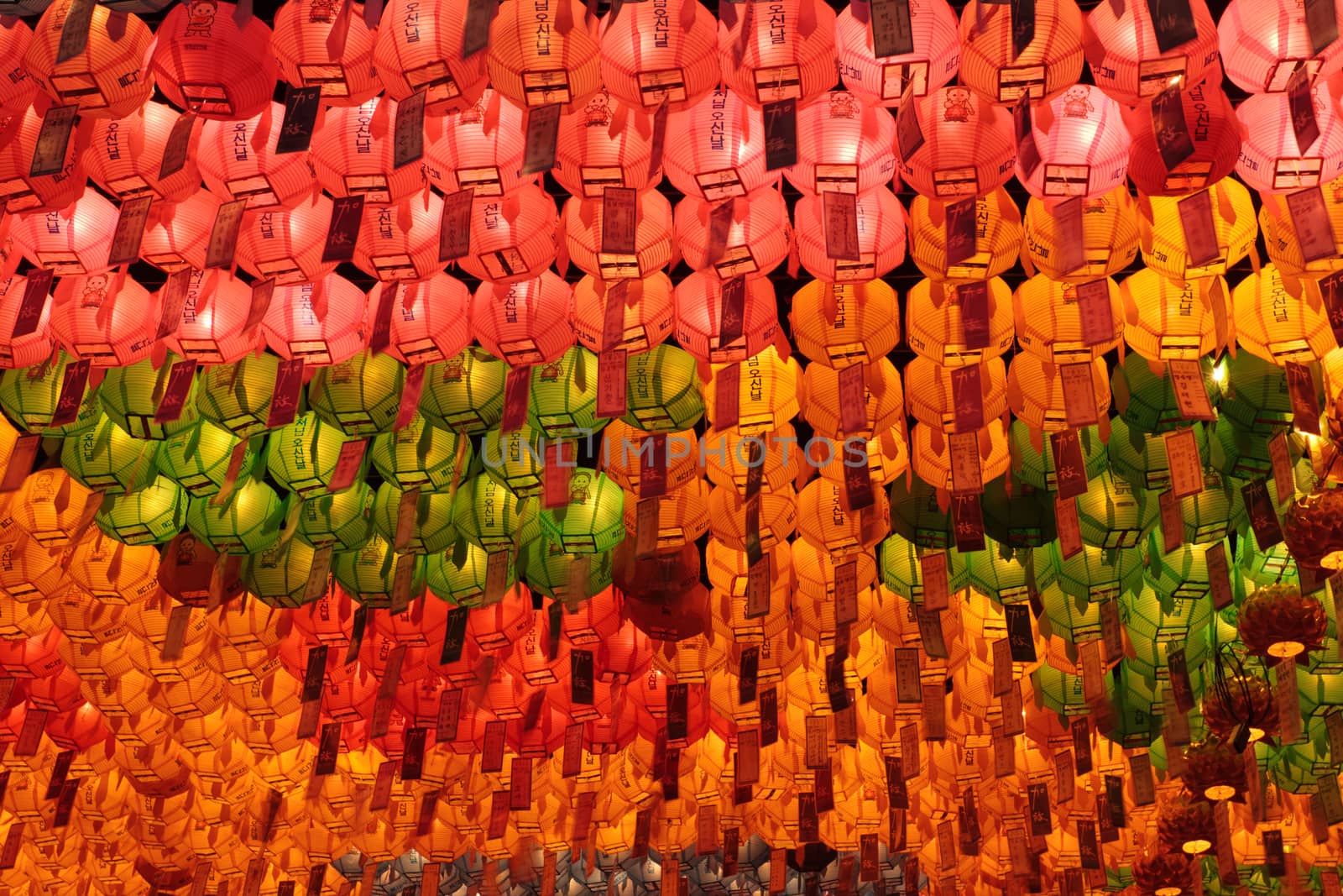 Many red, yellow and green glowing lanterns on Buddha's birthday