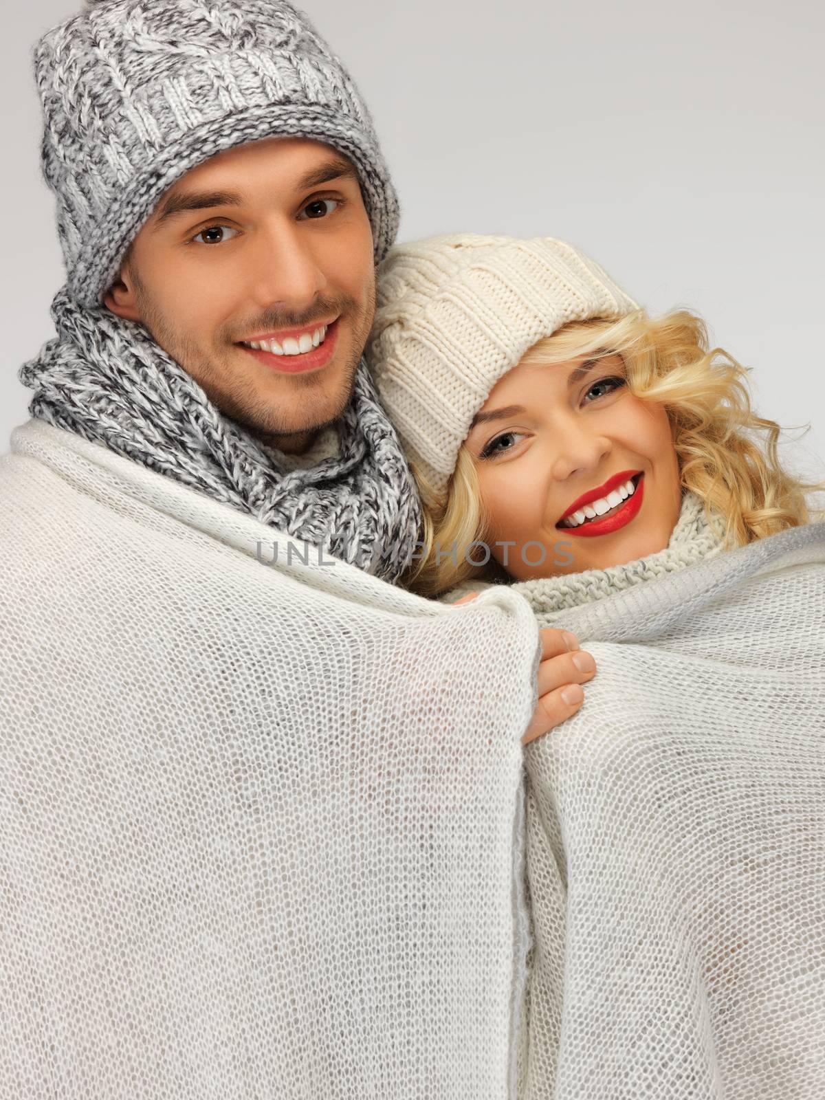 family couple under warm blanket by dolgachov
