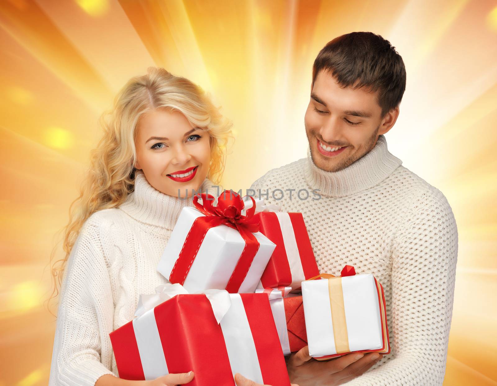 family couple in a sweaters with gift boxes by dolgachov