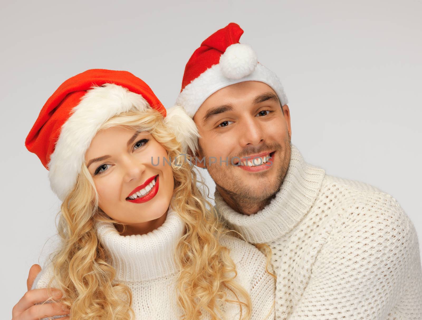 picture of family couple in sweaters and santa's hats