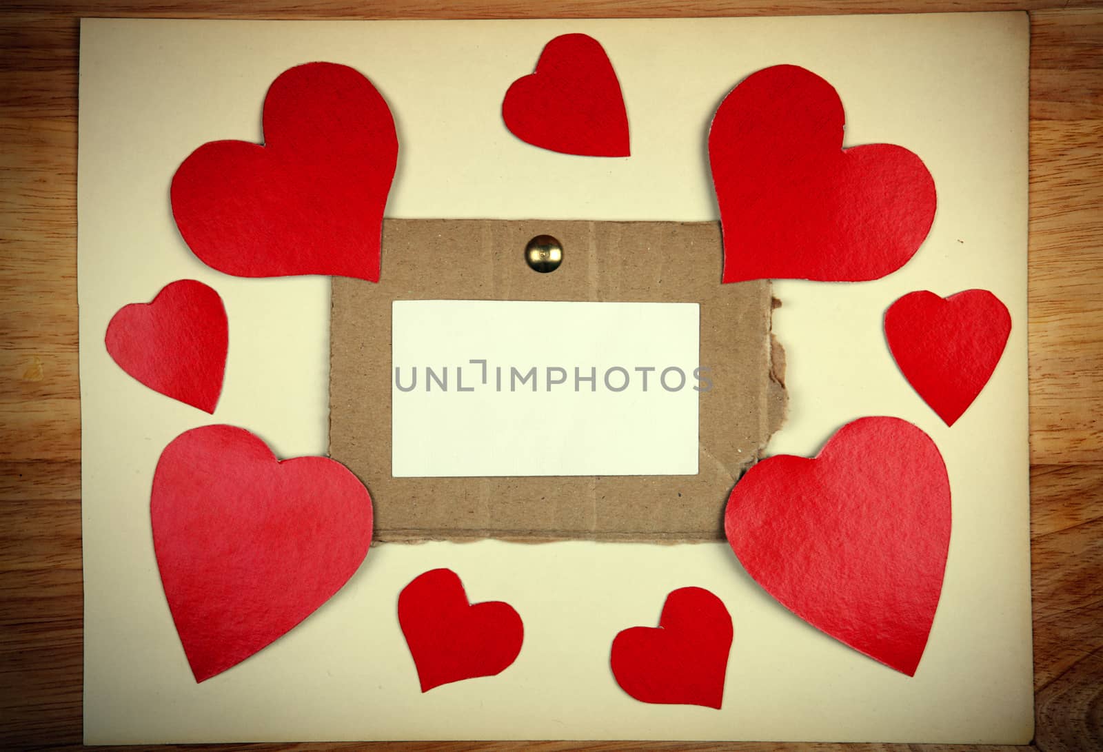 Notice Board with Heart Shapes on Wooden Background