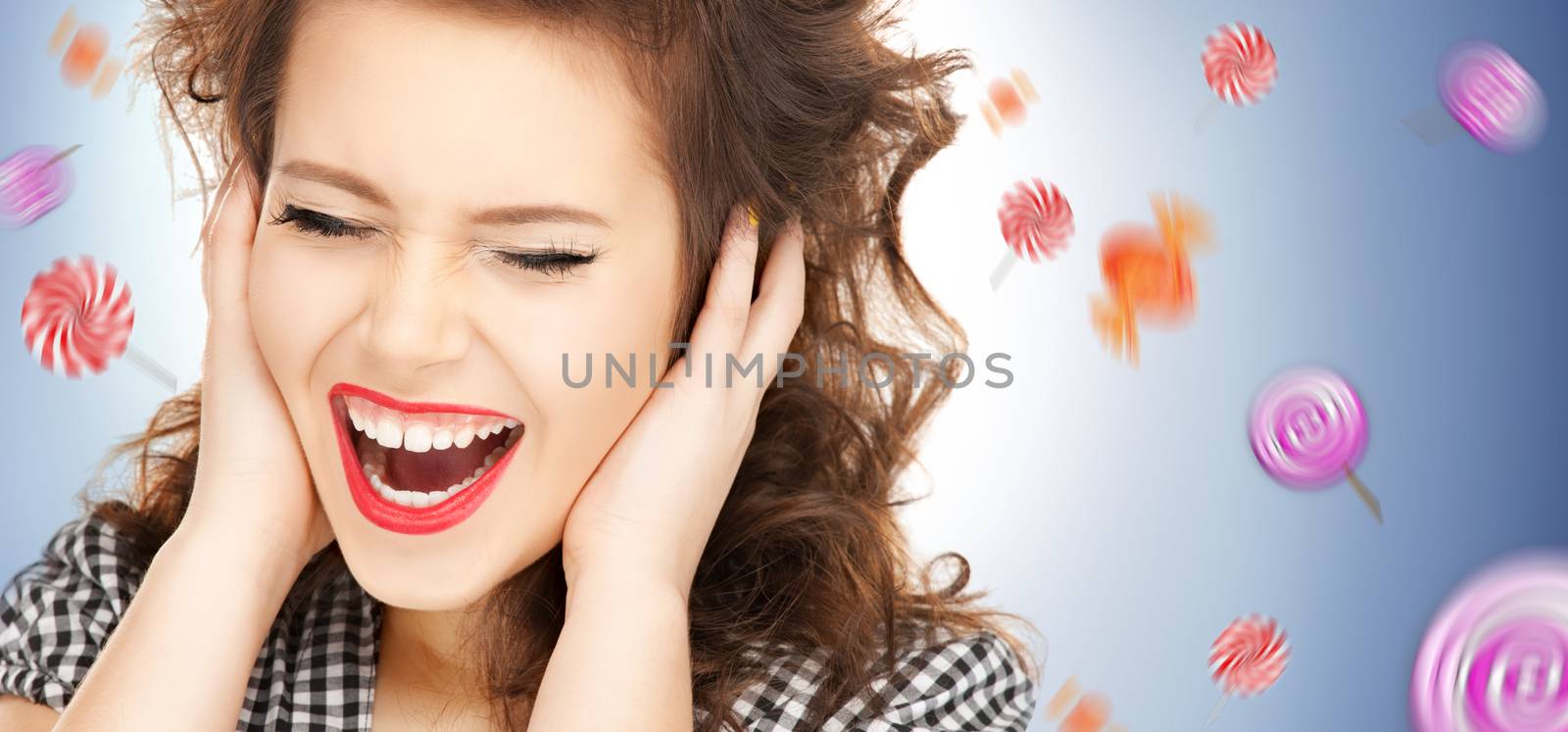 picture of woman with hands on ears and flying lollipops