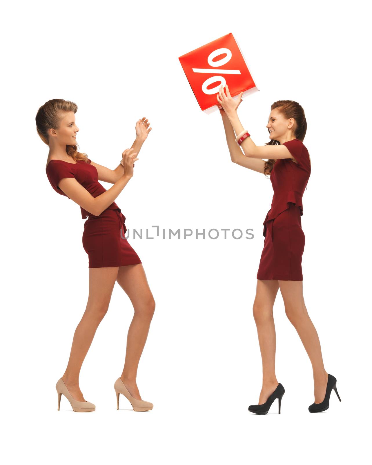 picture of two teenage girls in red dresses with percent sign