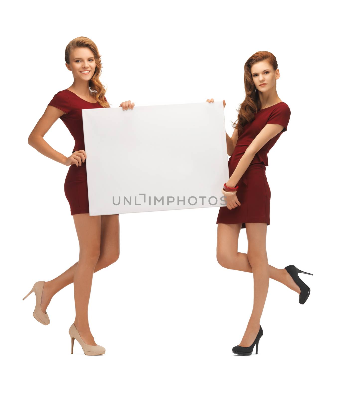 picture of two teenage girls in red dresses with blank board