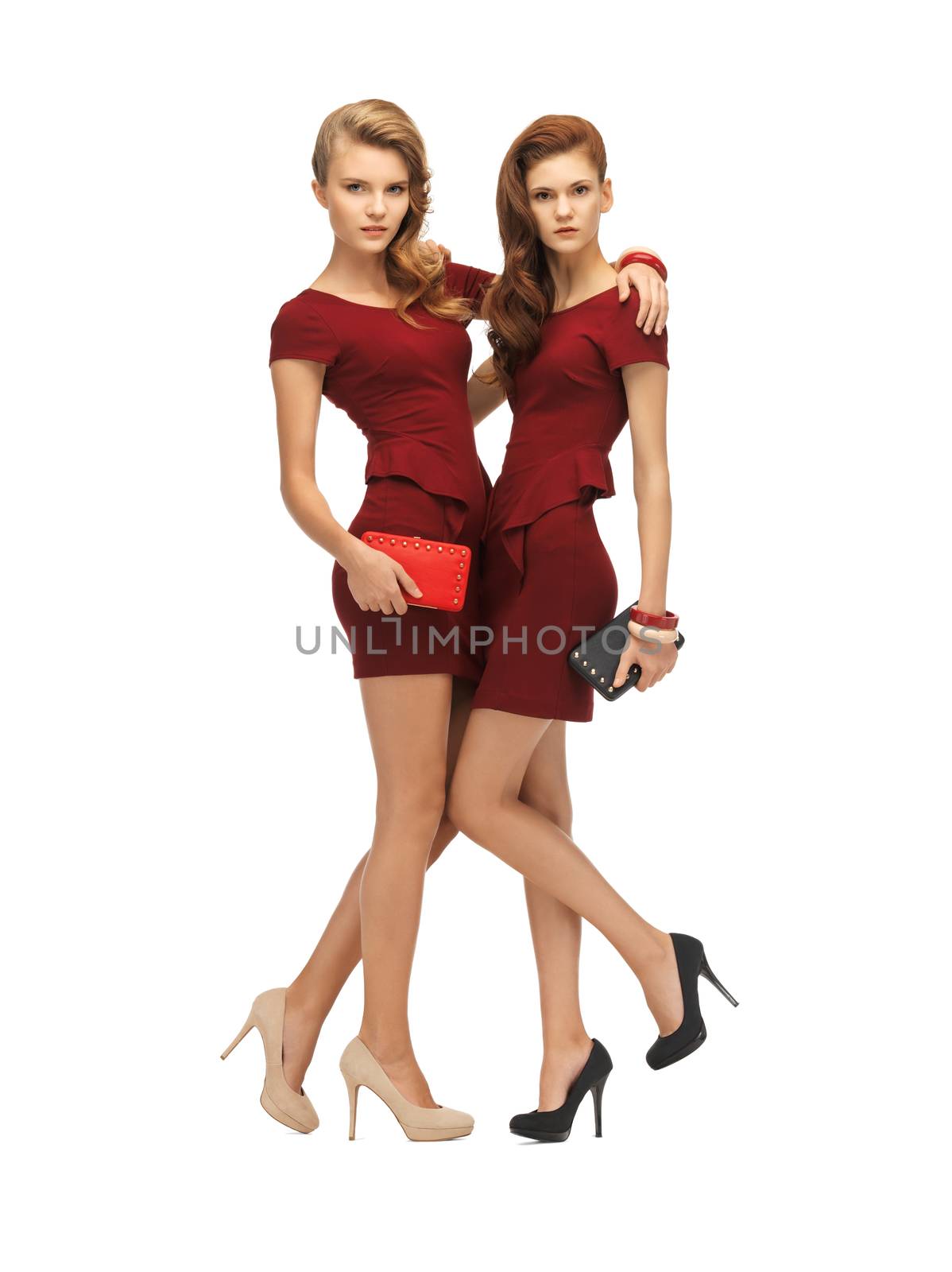 picture of two teenage girls in red dresses with clutches