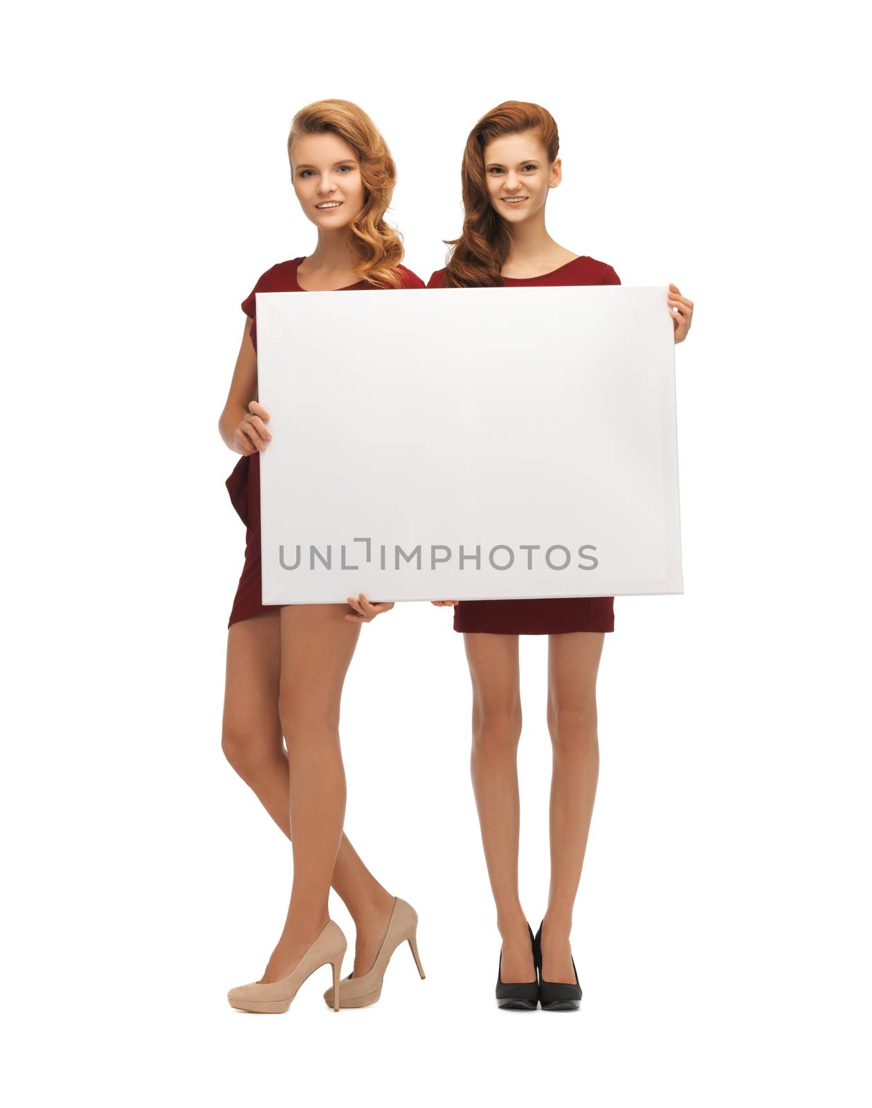 picture of two teenage girls in red dresses with blank board