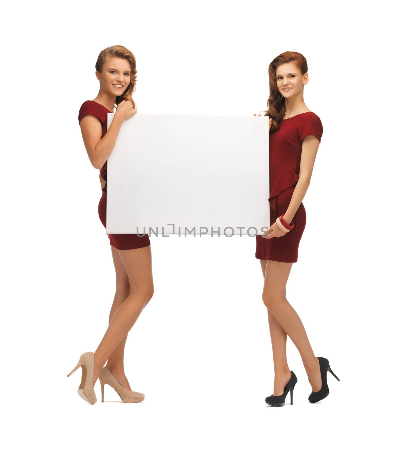 two teenage girls in red dresses with blank board by dolgachov