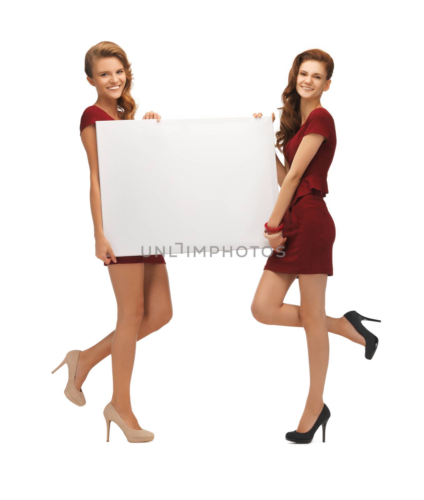 picture of two teenage girls in red dresses with blank board