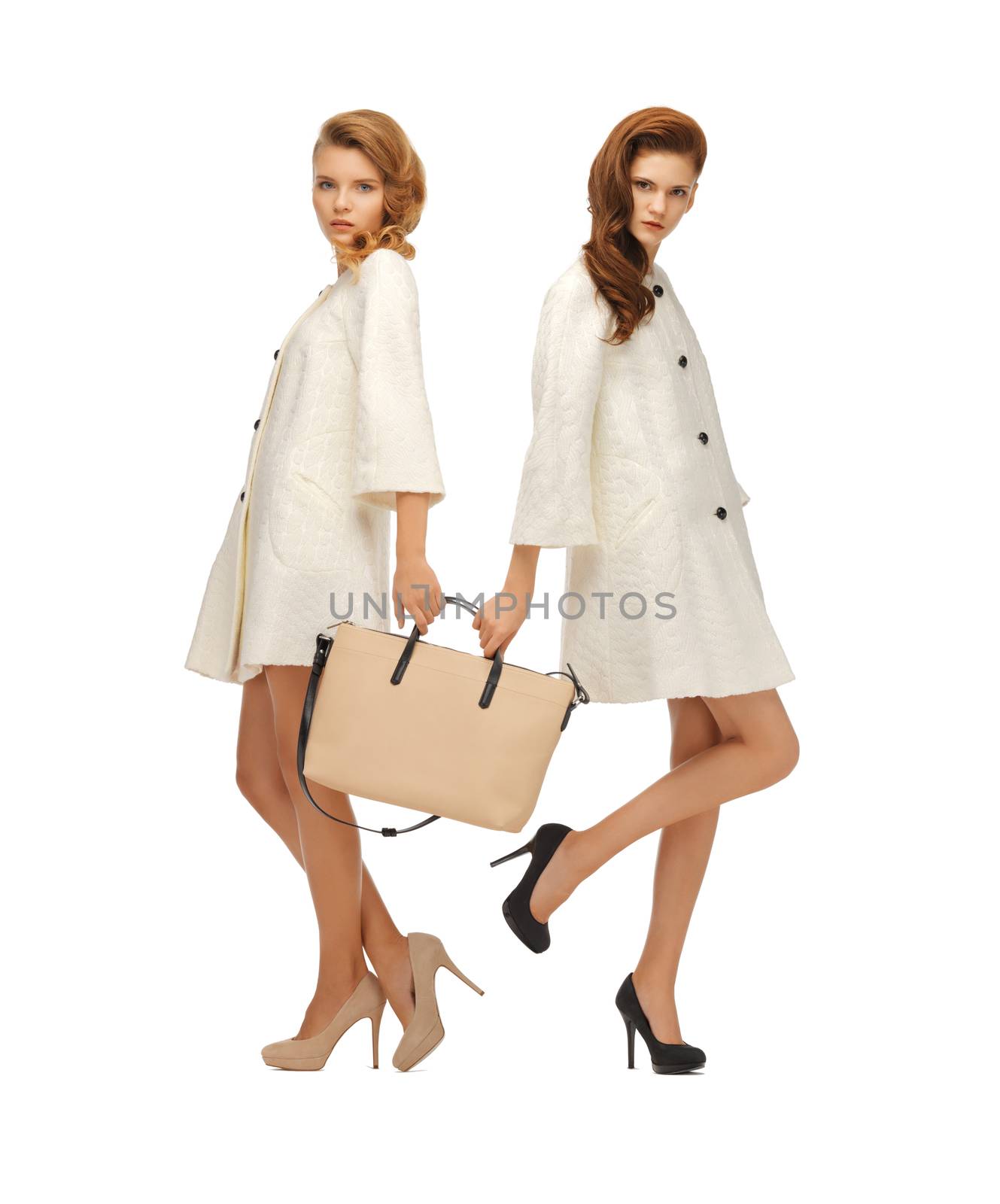 two teenage girls in white coats with bag by dolgachov