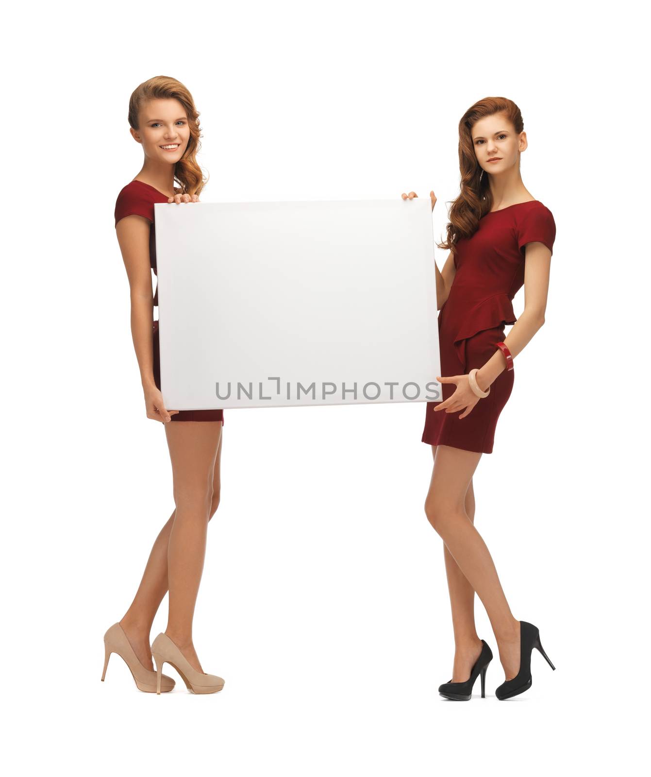 two teenage girls in red dresses with blank board by dolgachov