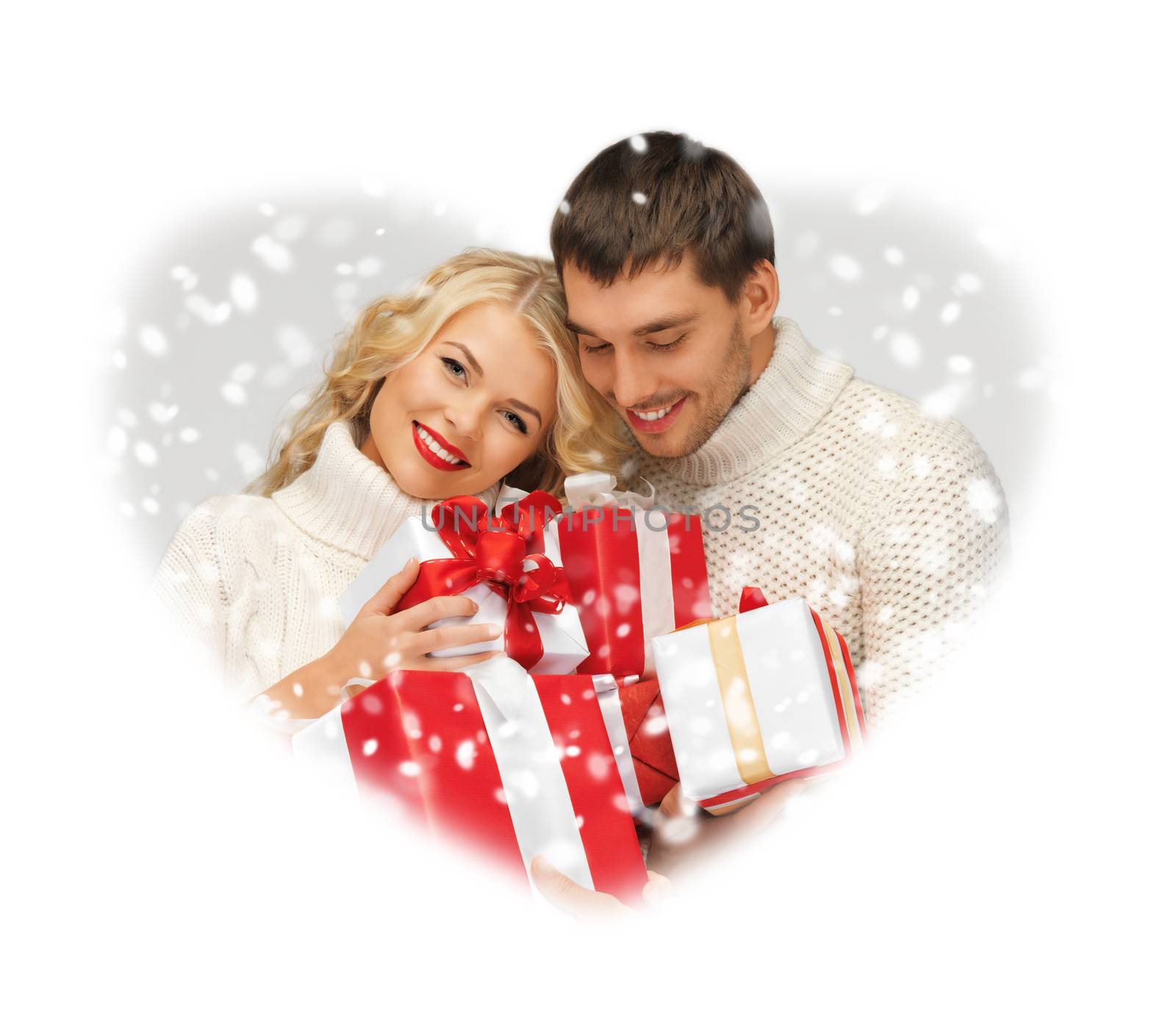 romantic couple in a sweaters with gift boxes by dolgachov