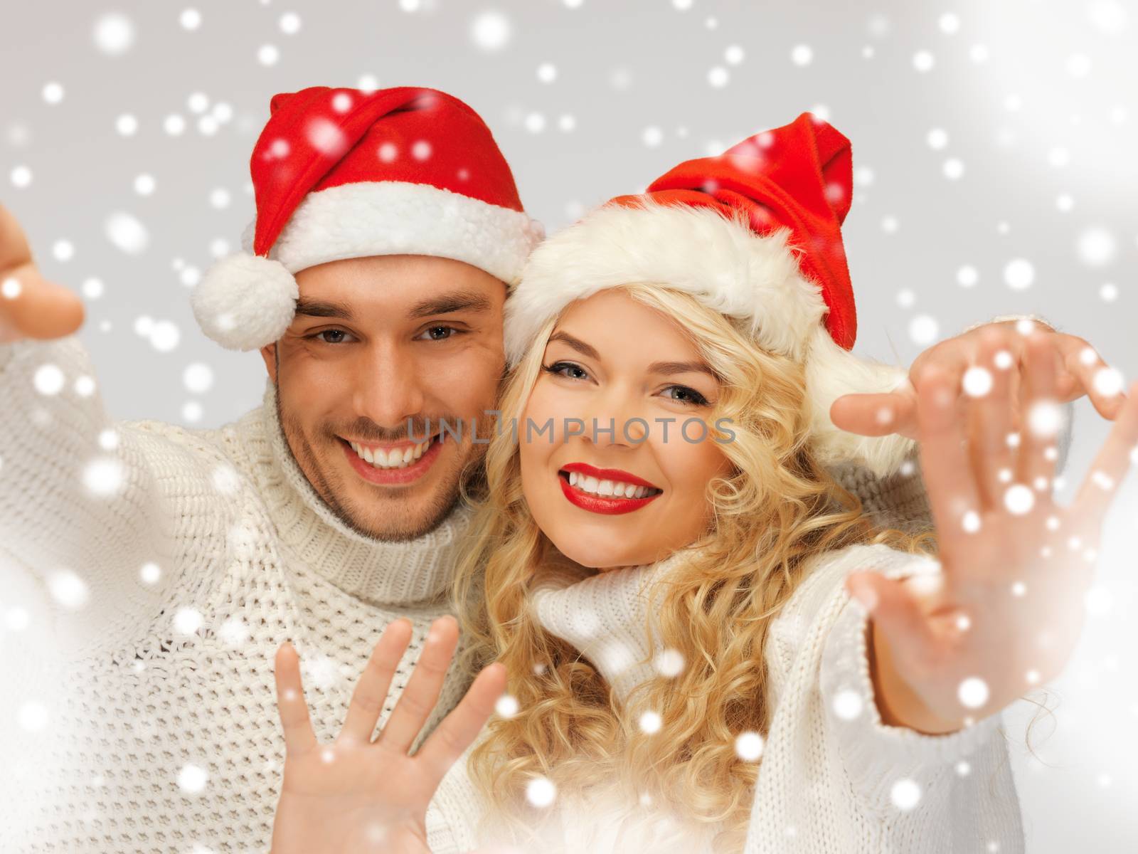 picture of family couple in sweaters and santa's hats