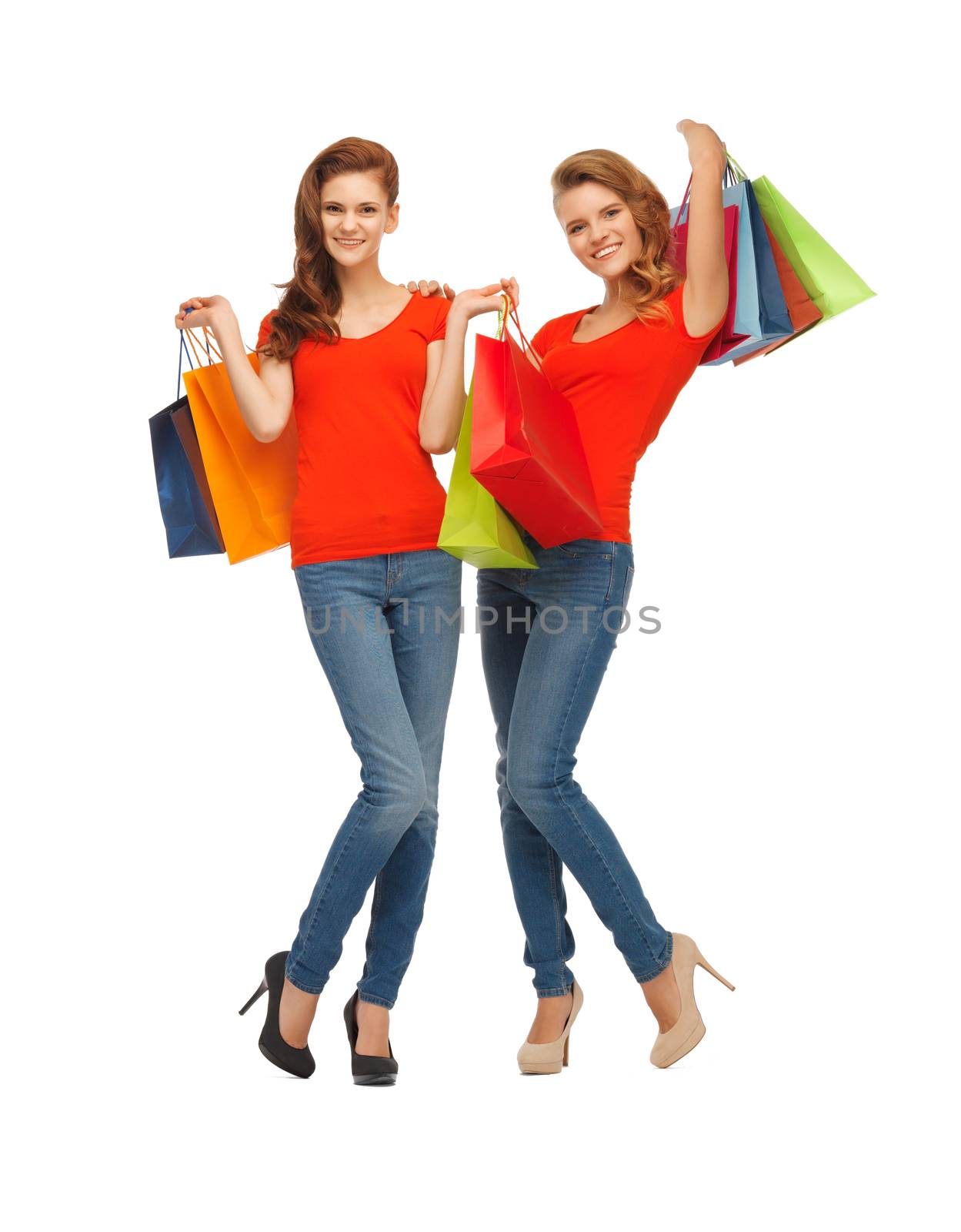 two teenage girls in red t-shirts with shopping bags