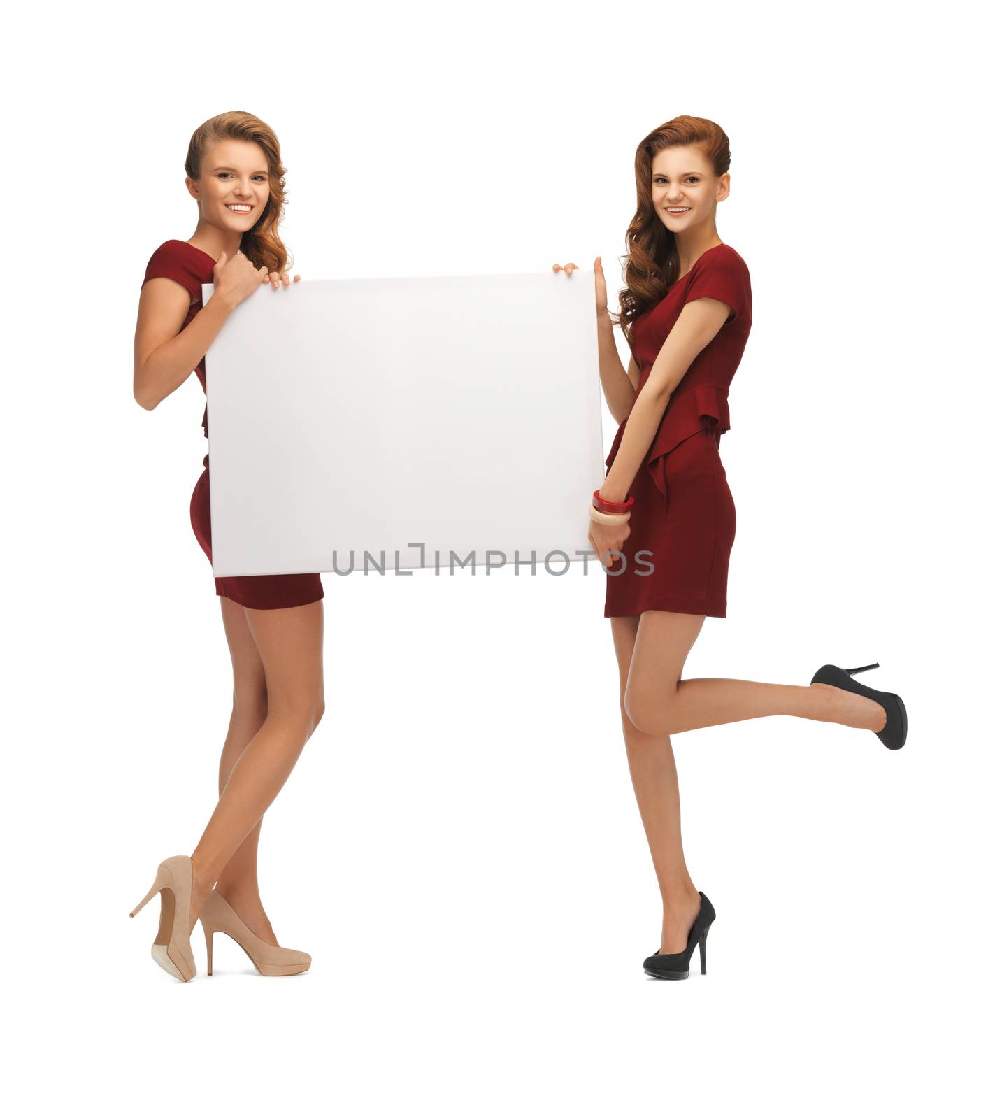 picture of two teenage girls in red dresses with blank board