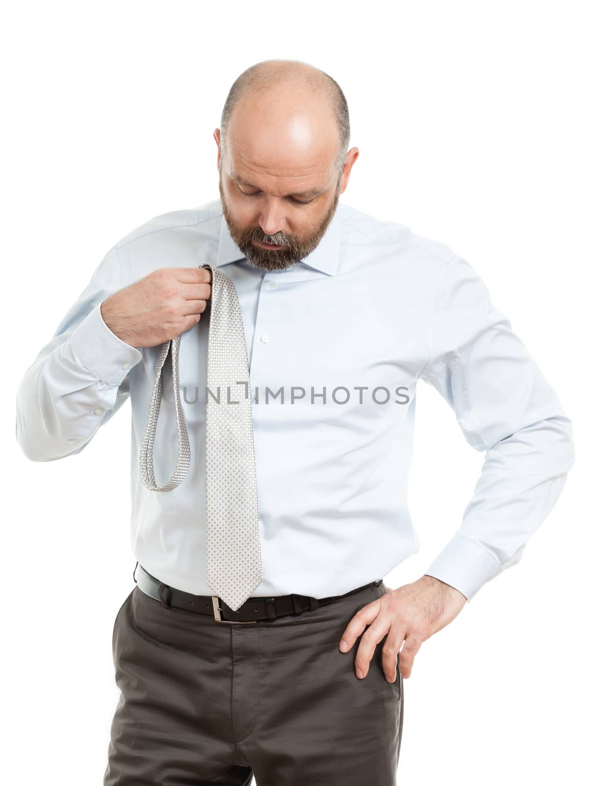 An image of a handsome business man who chooses a tie
