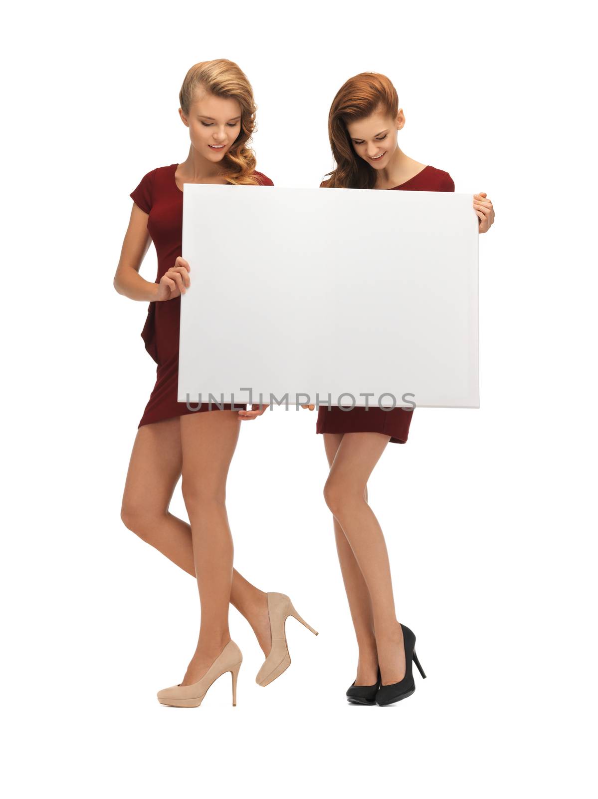 two teenage girls in red dresses with blank board by dolgachov