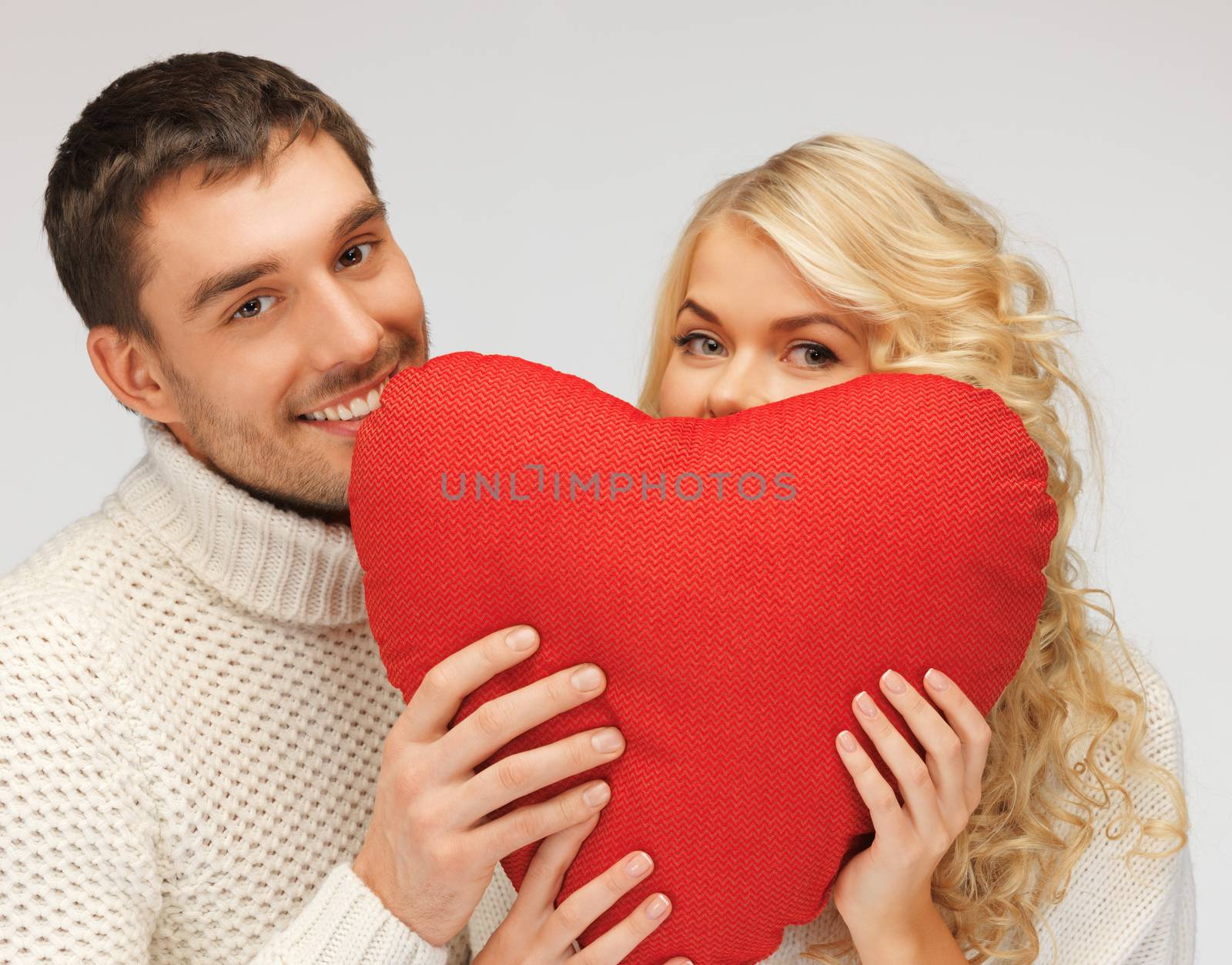 picture of family couple in a sweaters with heart (focus on man)