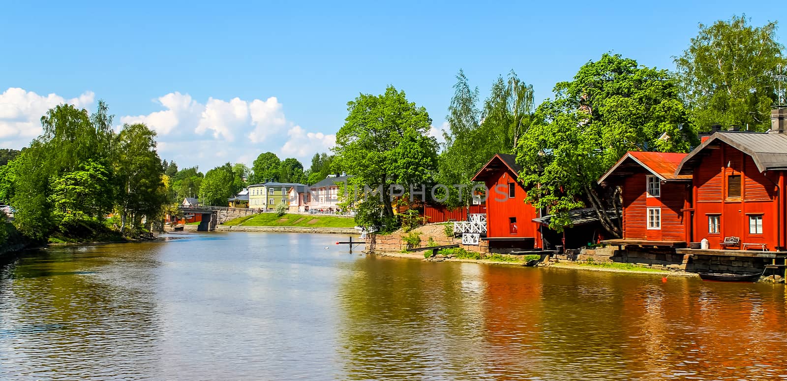 Old red warehouses alongside river Porvoo by Alexanderphoto