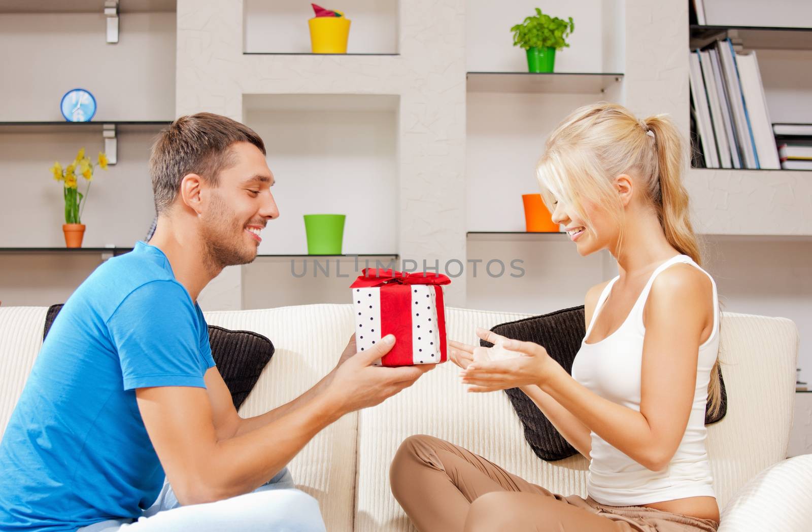 happy romantic couple with gift by dolgachov