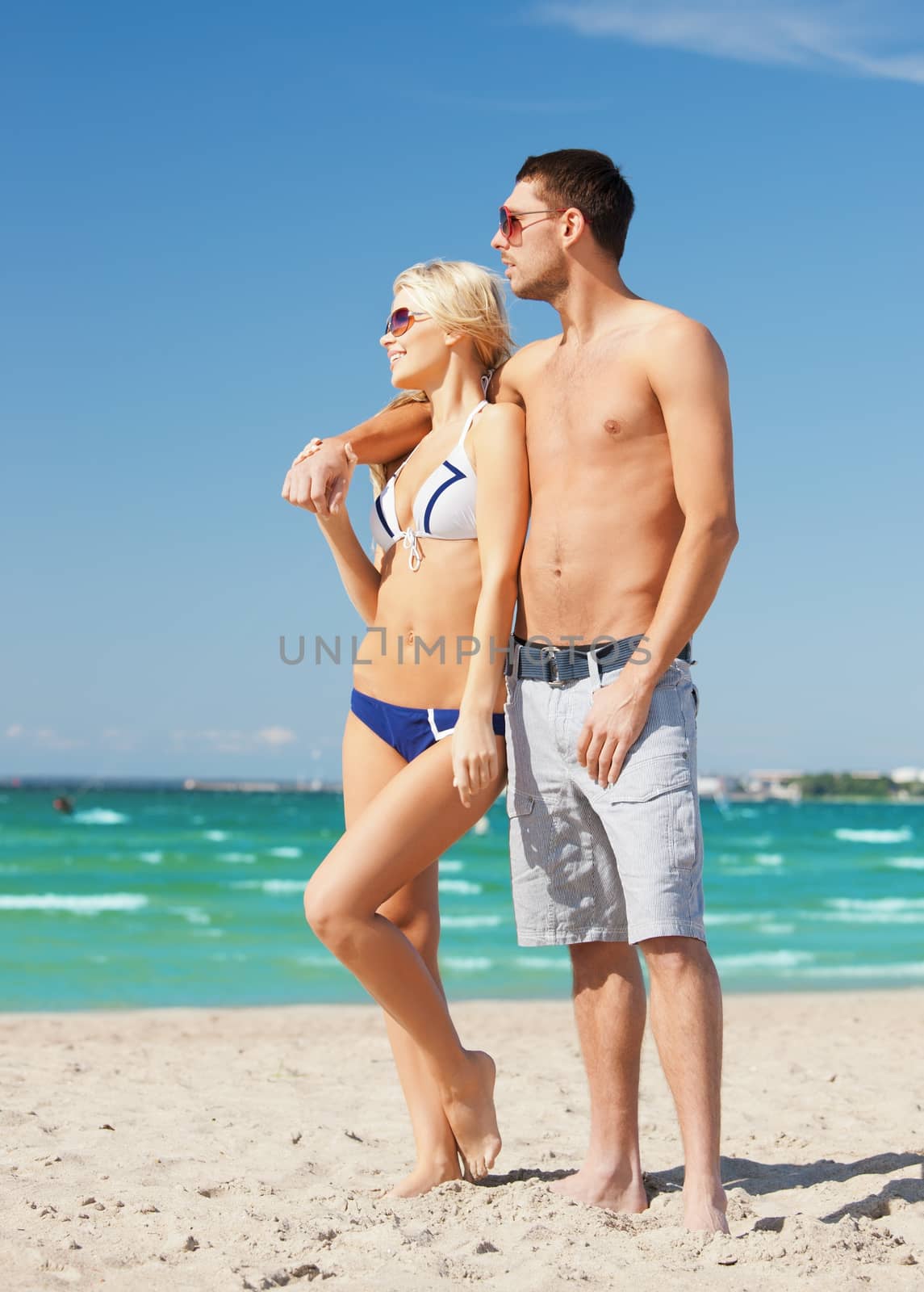 picture of happy couple in sunglasses on the beach.