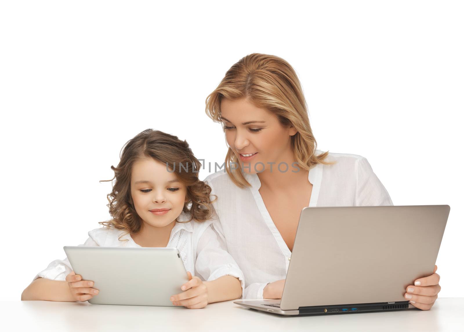 mother and daughter with laptop and tablet pc