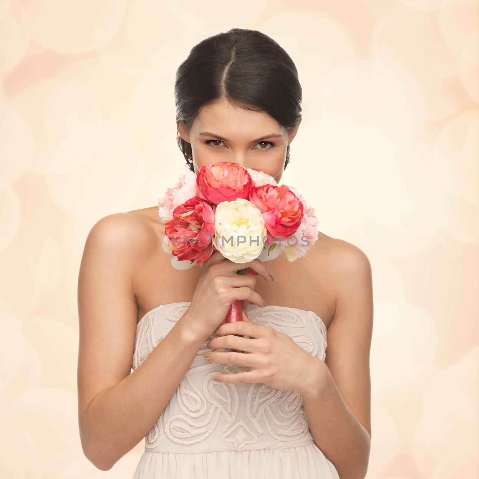 woman smelling bouquet of flowers by dolgachov