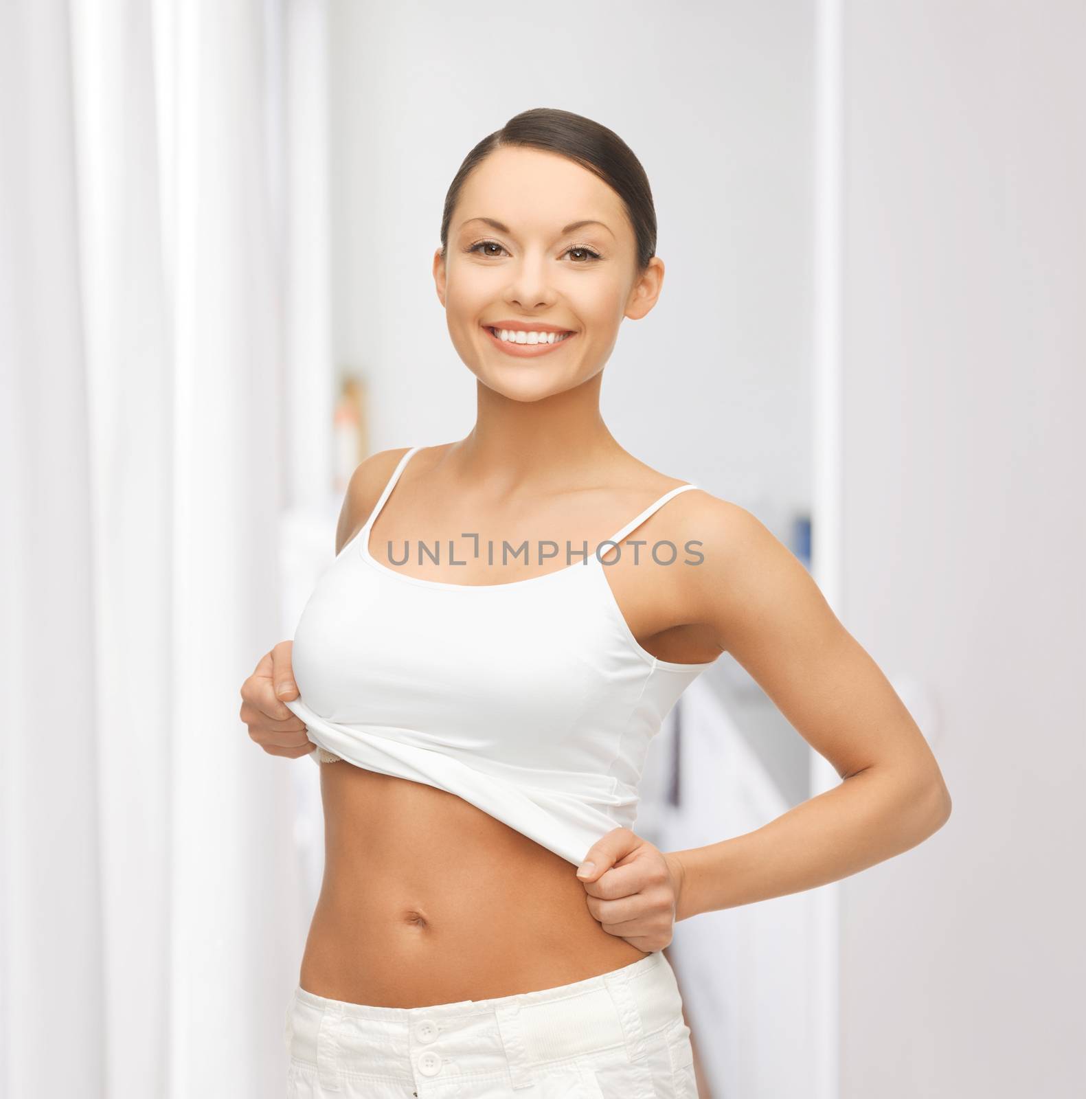 woman taking off blank white t-shirt by dolgachov