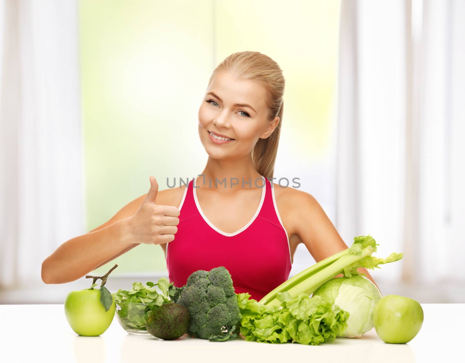 woman shows thumbs up with organic food by dolgachov