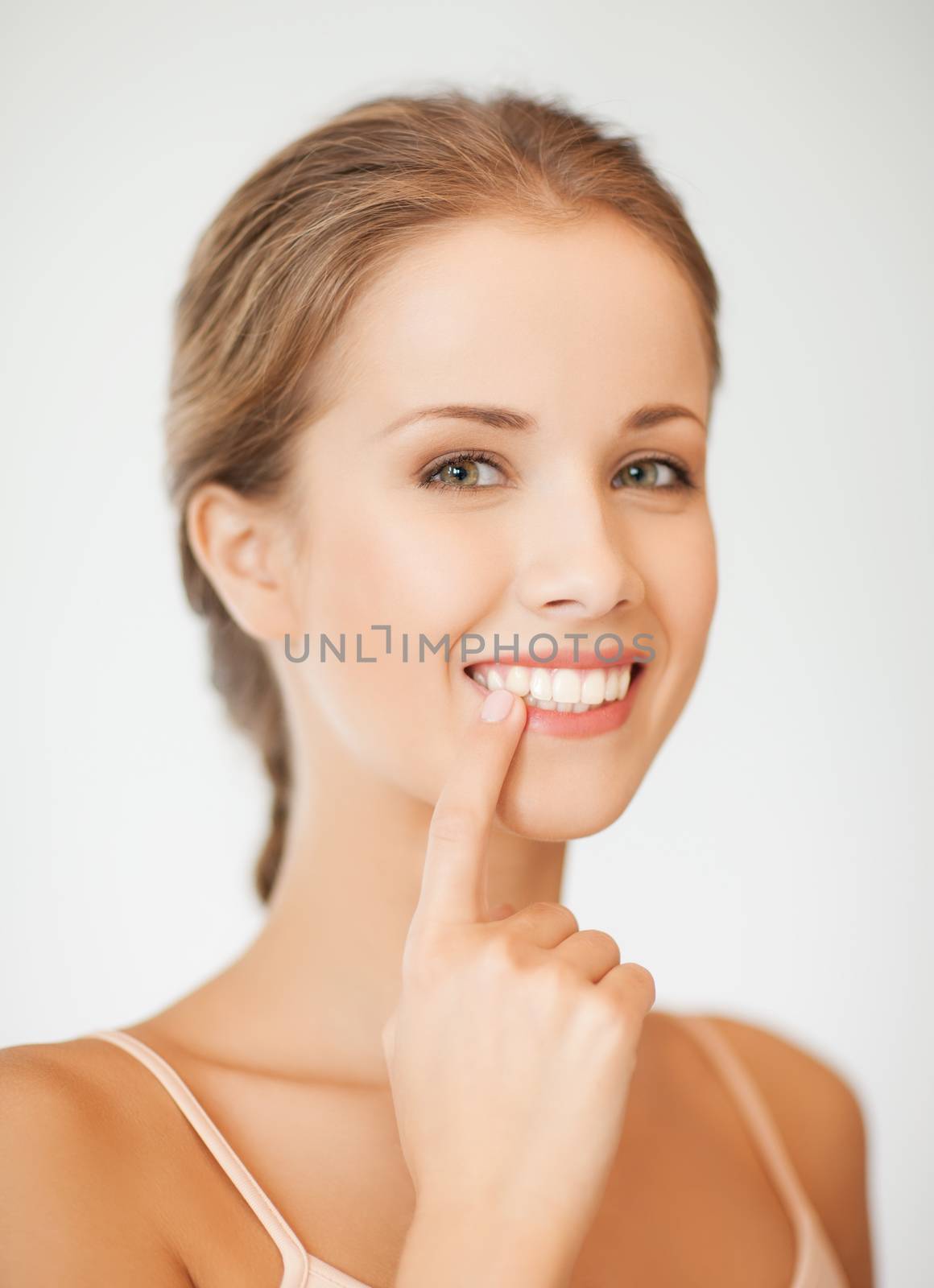 woman showing her teeth by dolgachov