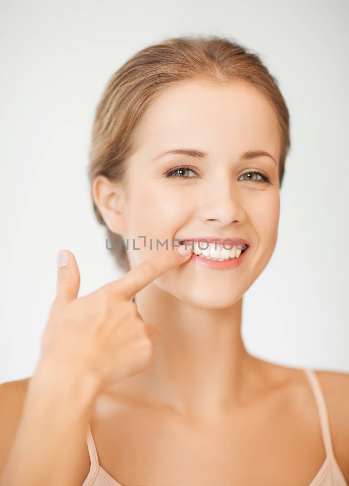 face of beautiful woman showing her teeth