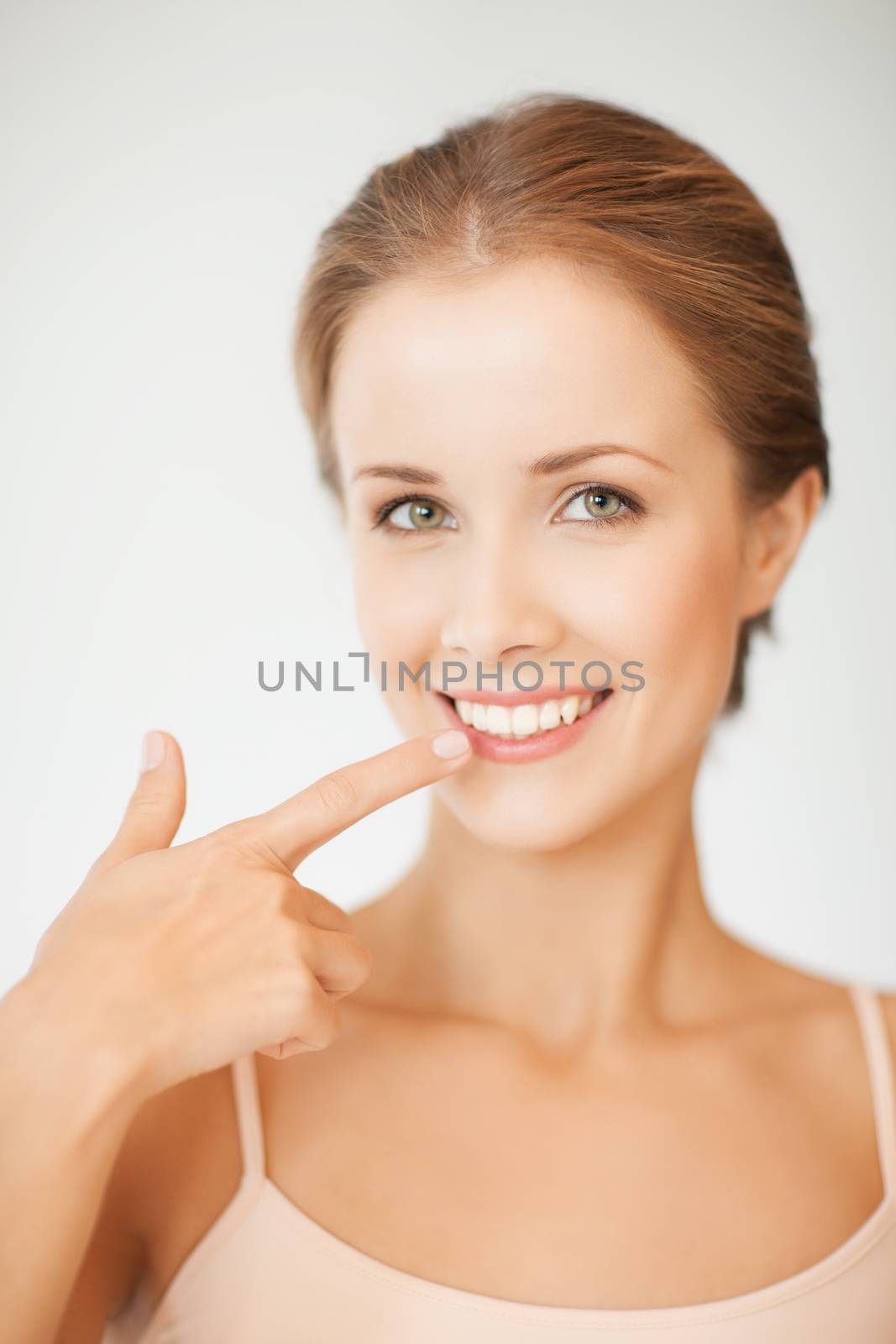 woman showing her teeth by dolgachov