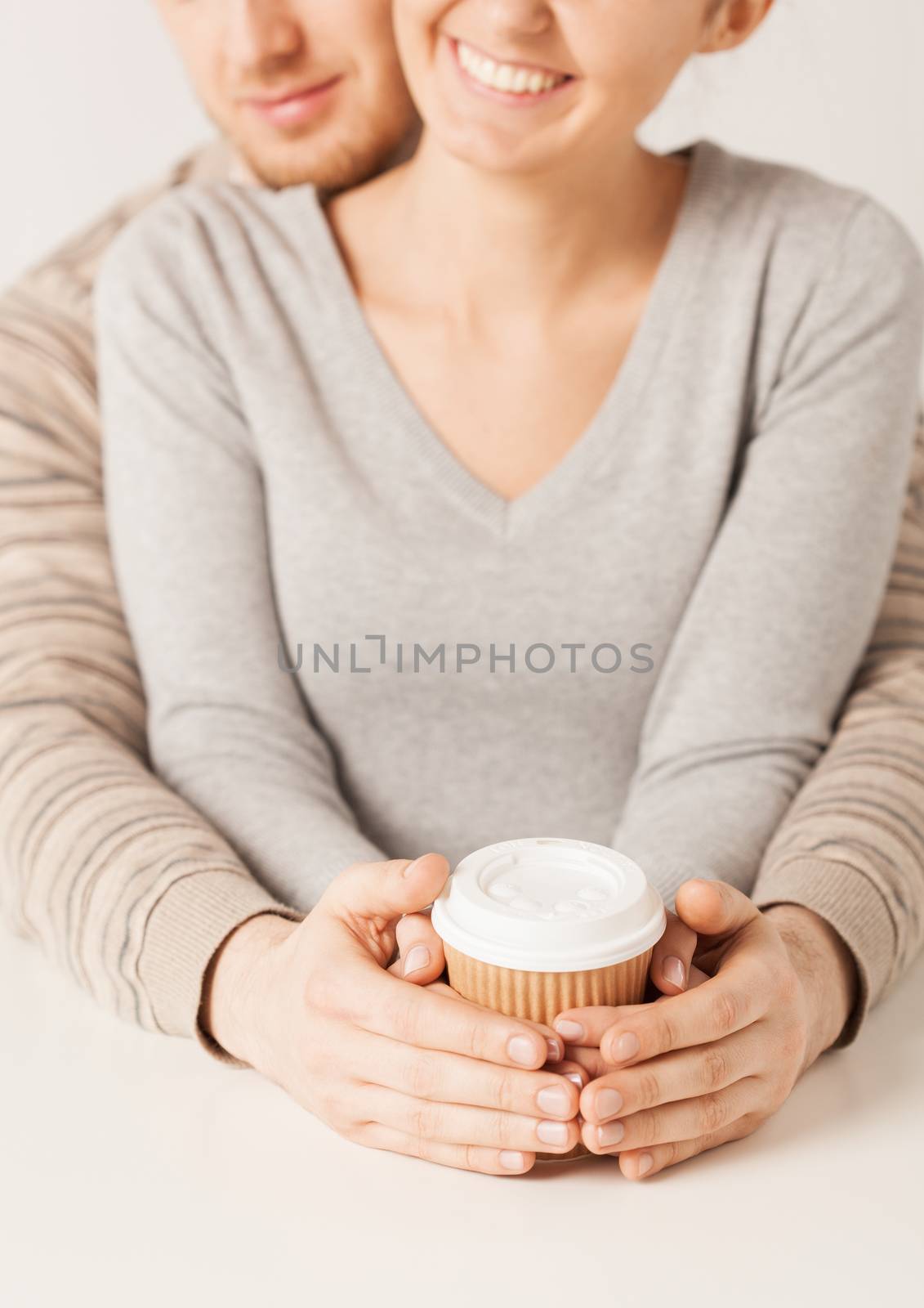 woman and man hands holding take away coffee cup