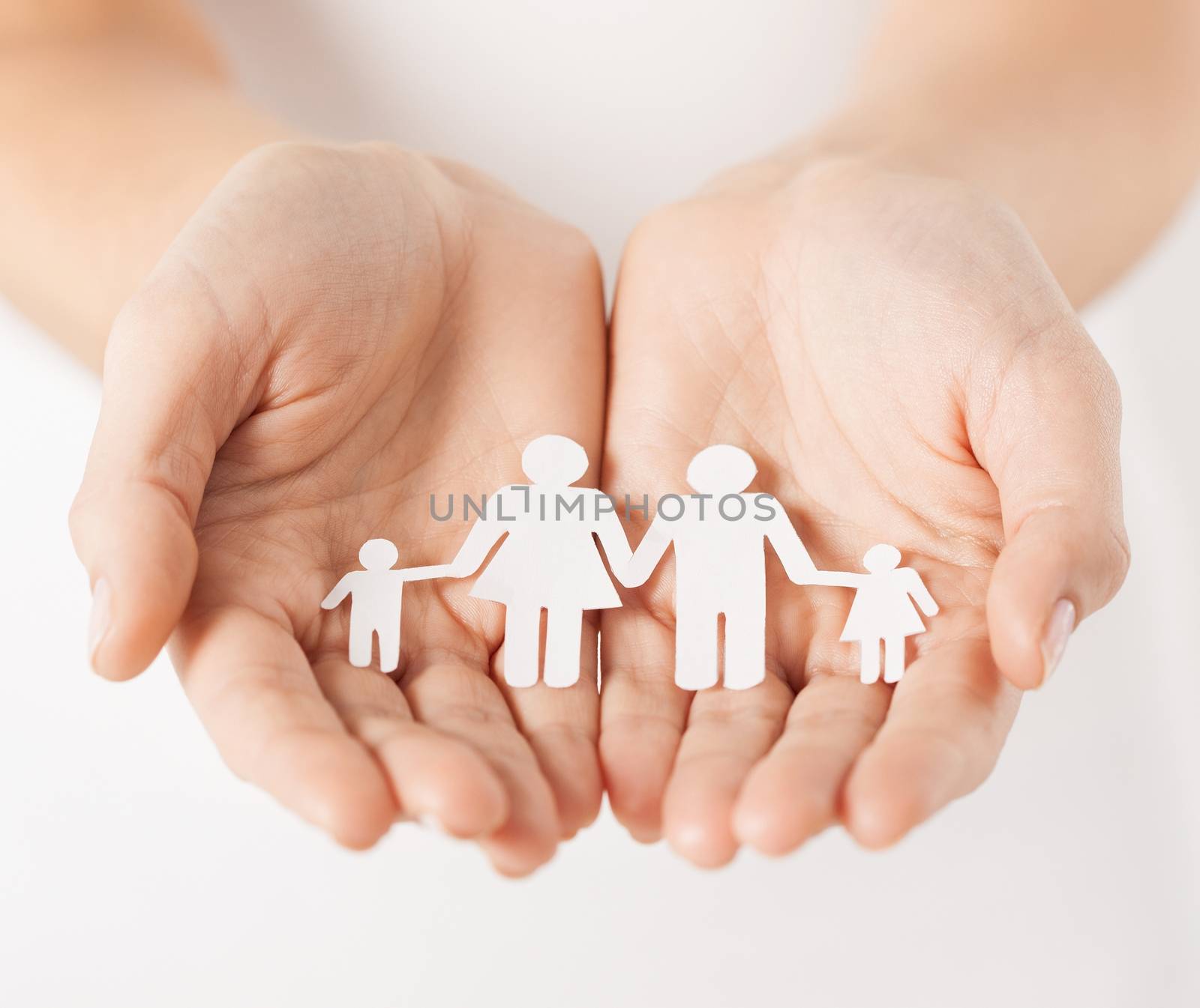 womans hands with paper man family by dolgachov