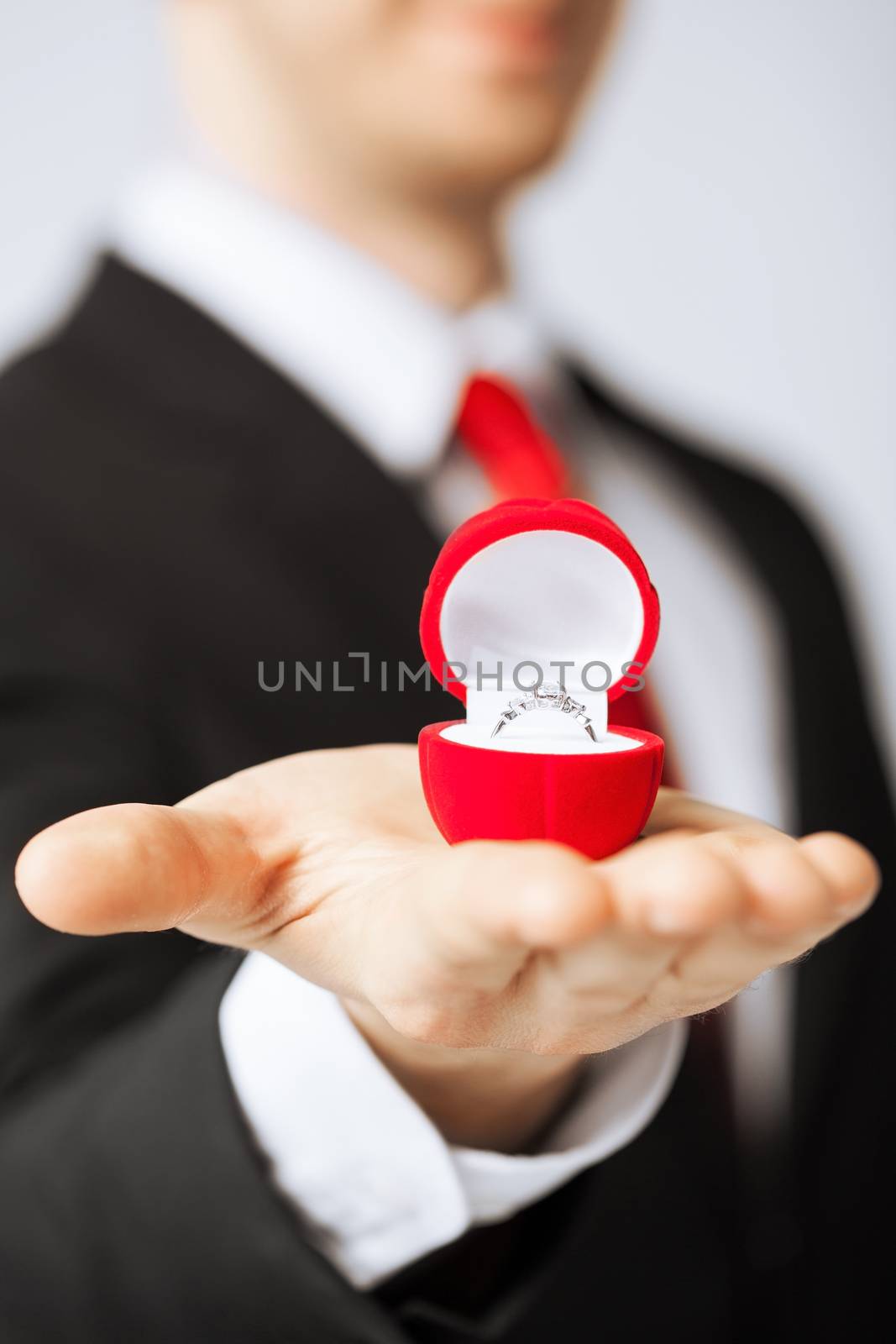 man making proposal with wedding ring and gift box.